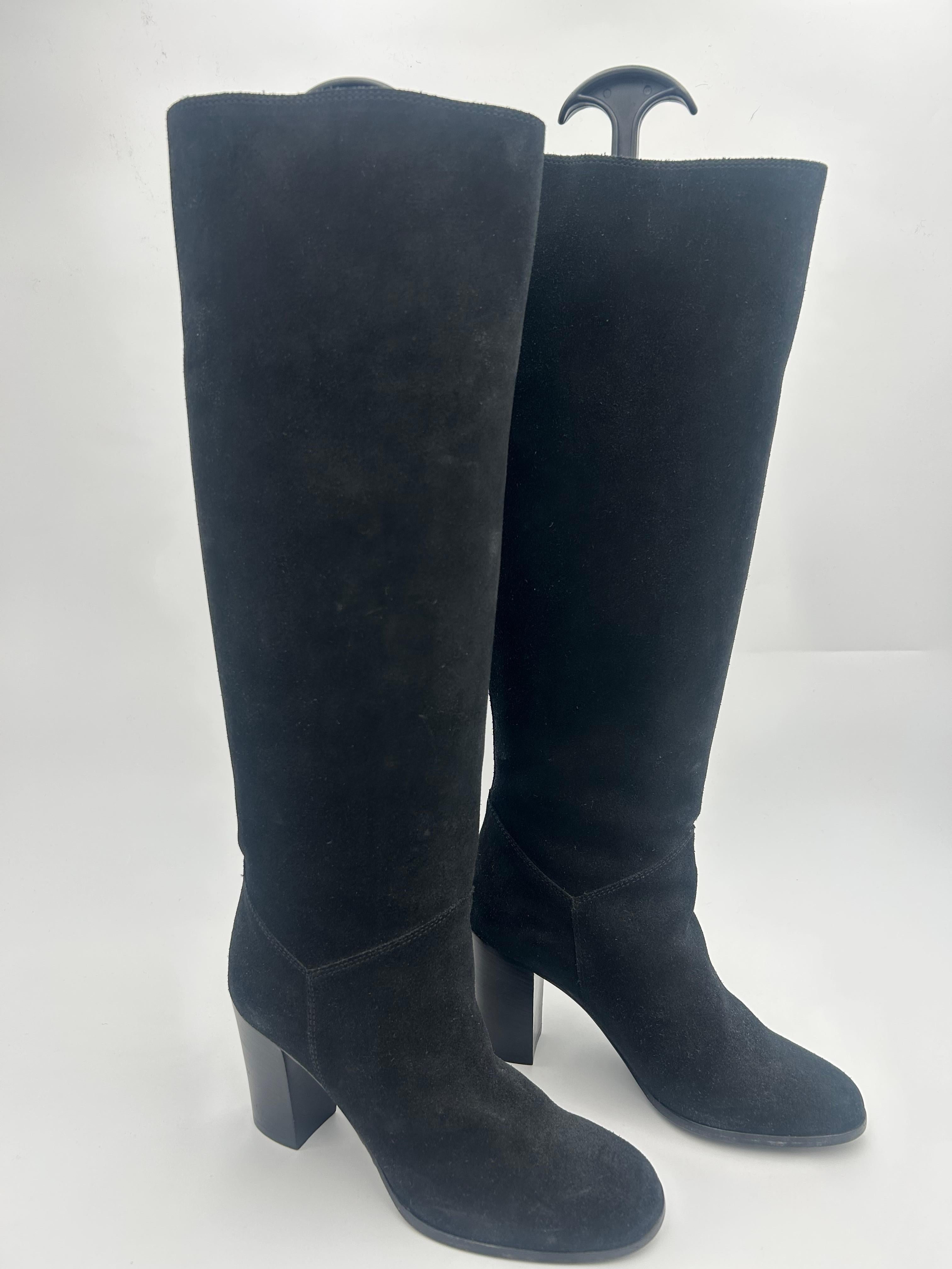 Chanel Knee High Black Suede Boots. Beautiful Chanel boots in perfect condition, never been worn before. This boots really represents the brands classiness and originality, making this a really sought after piece among collectors and enthusiastic of