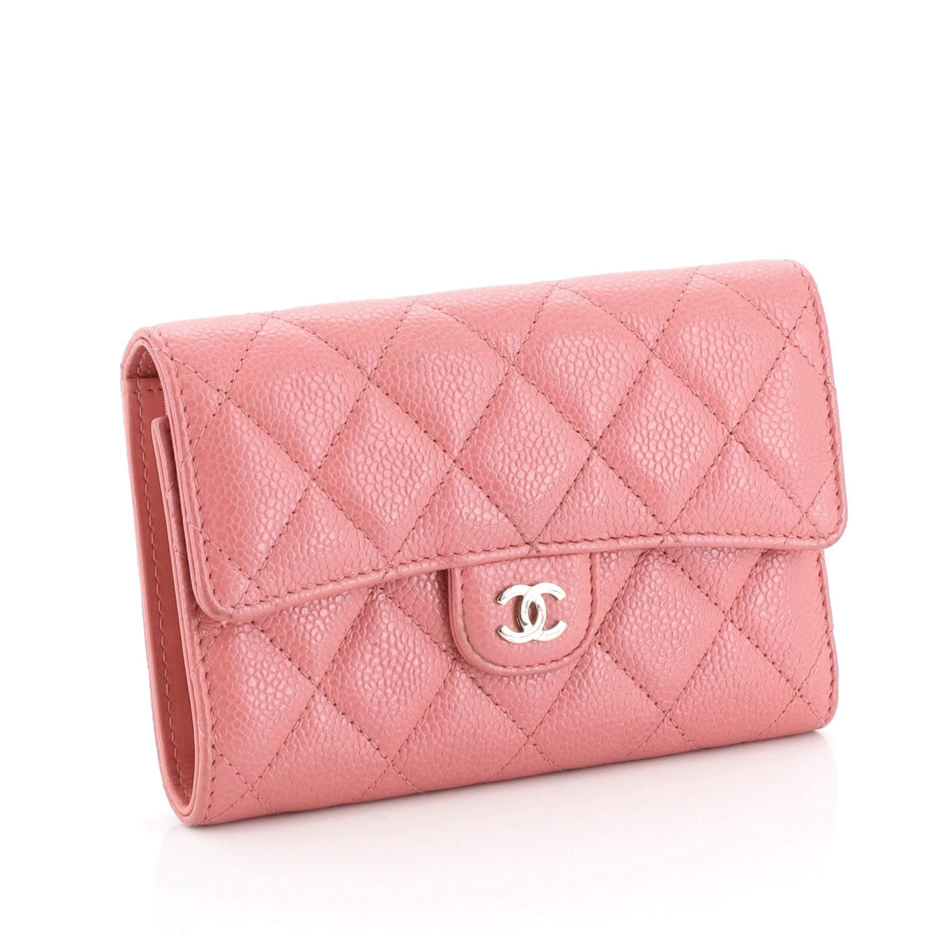 This Chanel L-Flap Wallet Quilted Caviar Compact is an everyday piece with compact design offering multiple practical features. Crafted from pink quilted caviar leather, it features CC logo at front flap and gold-tone hardware. Its snap closure