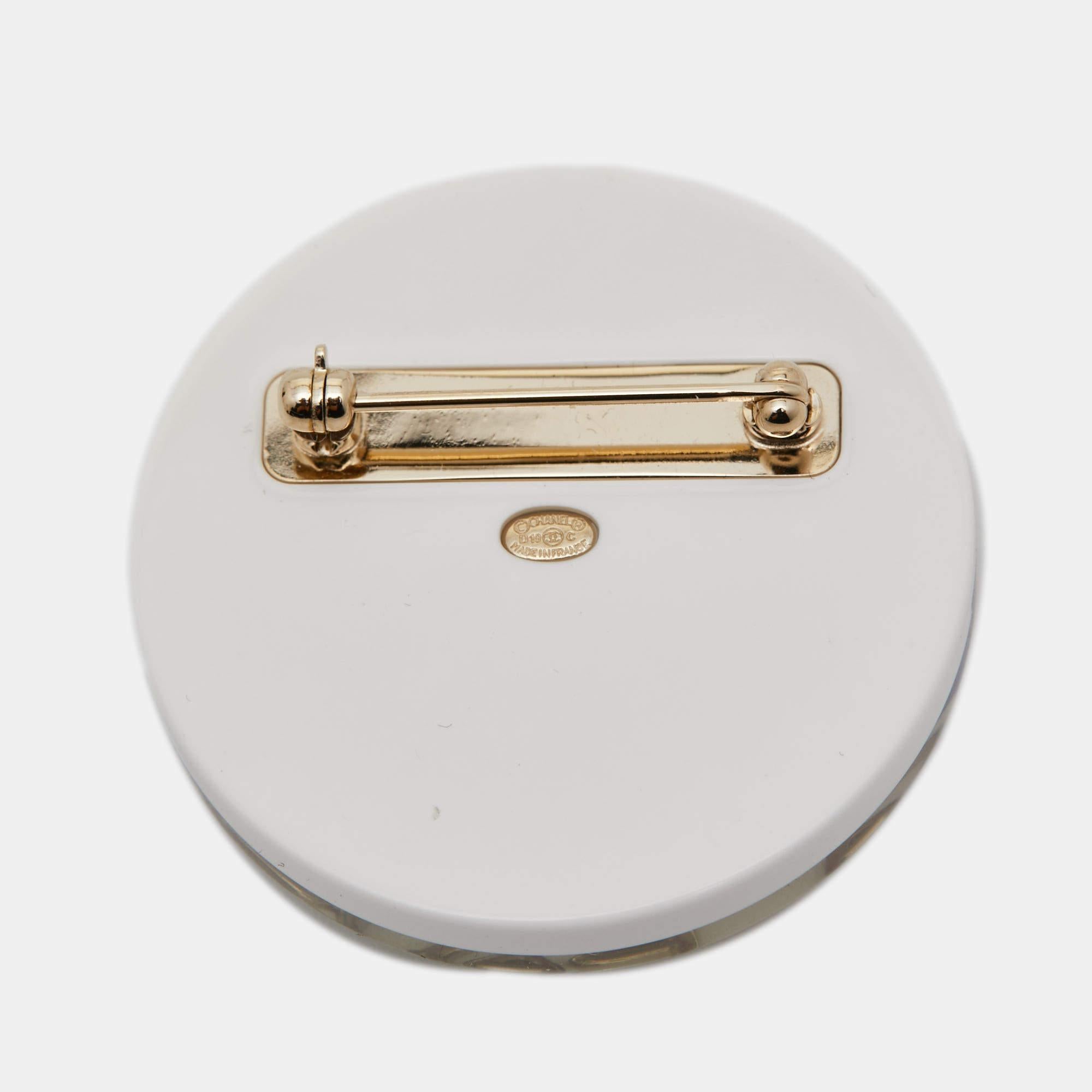 The Chanel brooch is a sophisticated accessory featuring a timeless design. Crafted from high-quality plastic resin, it showcases Chanel's iconic elegance with meticulous detailing. The brooch seamlessly blends luxury and style, making it a coveted