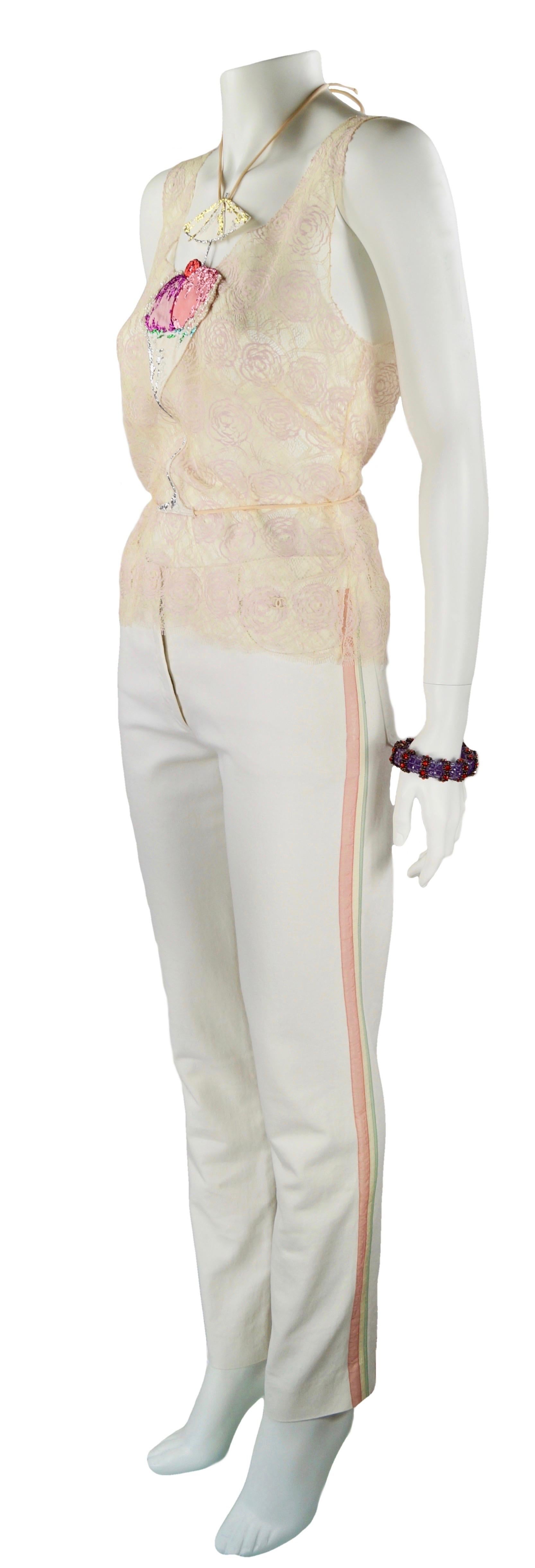 CHANEL Resort 2004
Pale pink and beige camelia lace top with ice cream Martini cup
Size FR 42
Made in Italy
63% cotton
37% nylon
Flat measures:
Length cm. 56
Shoulders cm. 30
Bust cm. 42
Excellent condition 
White jeans with green and pink side