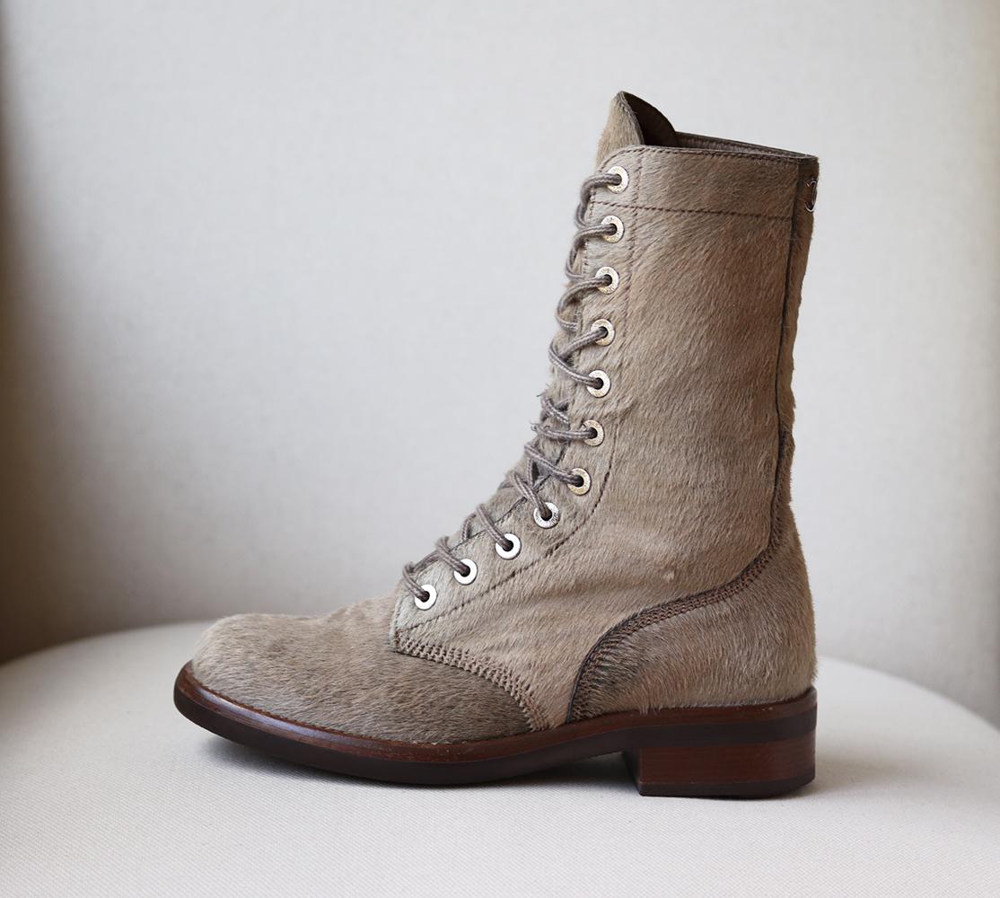 Made from beige calf hair, these lace-up ankle boots are carefully traced with optic tonal stitching and have a metal logo at the back.
Heel measures approximately 38 mm/ 1.5 inch.
Beige calf hair.
Lace-up fasteing along front.
Made in Italy.
Does
