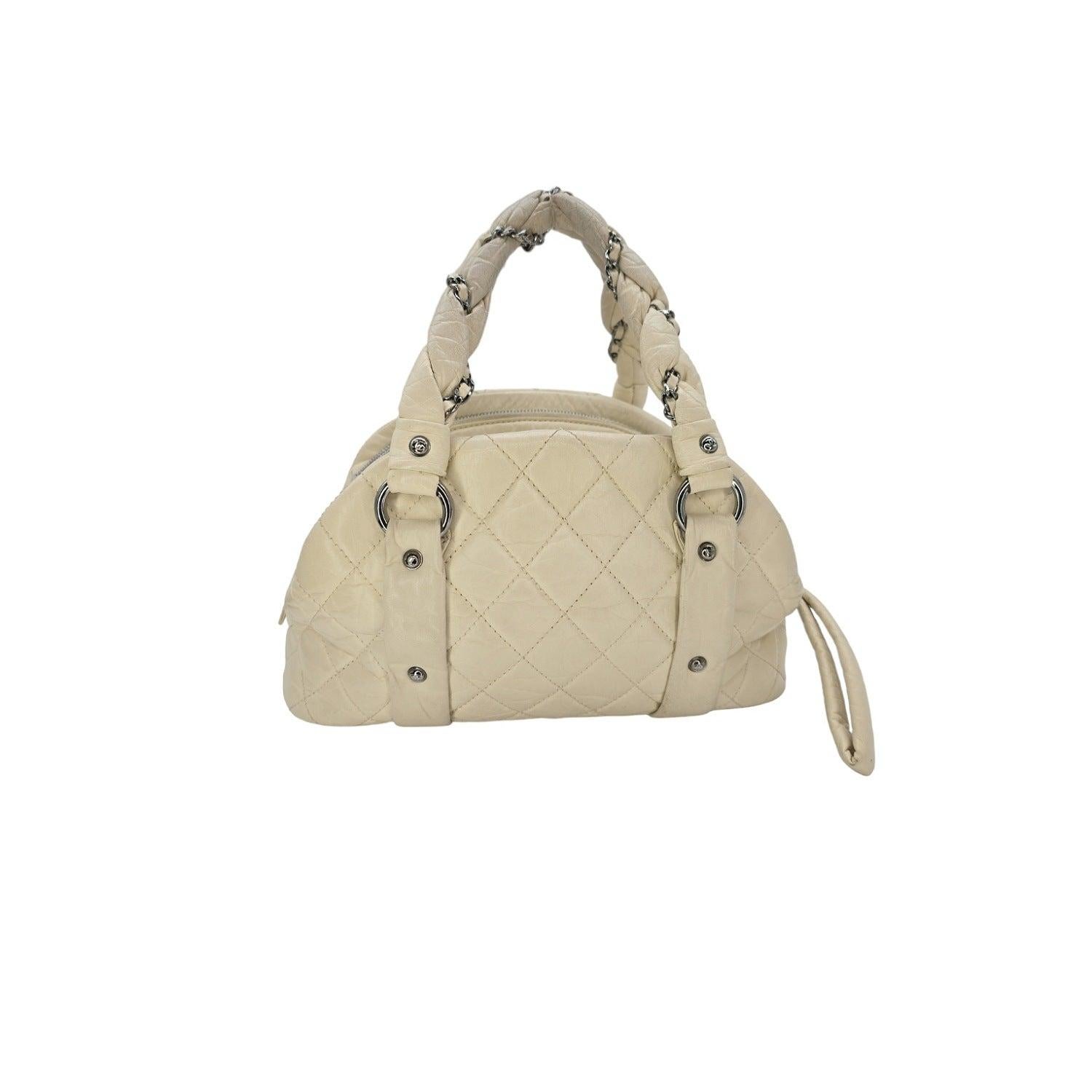 The Chanel Lady Braid Bowling Bag is a timeless and luxurious addition to any collection. Crafted from supple distressed calfskin leather, it features chain and leather braided handles, a CC logo zipper pull, and 3 separate compartments, one with an