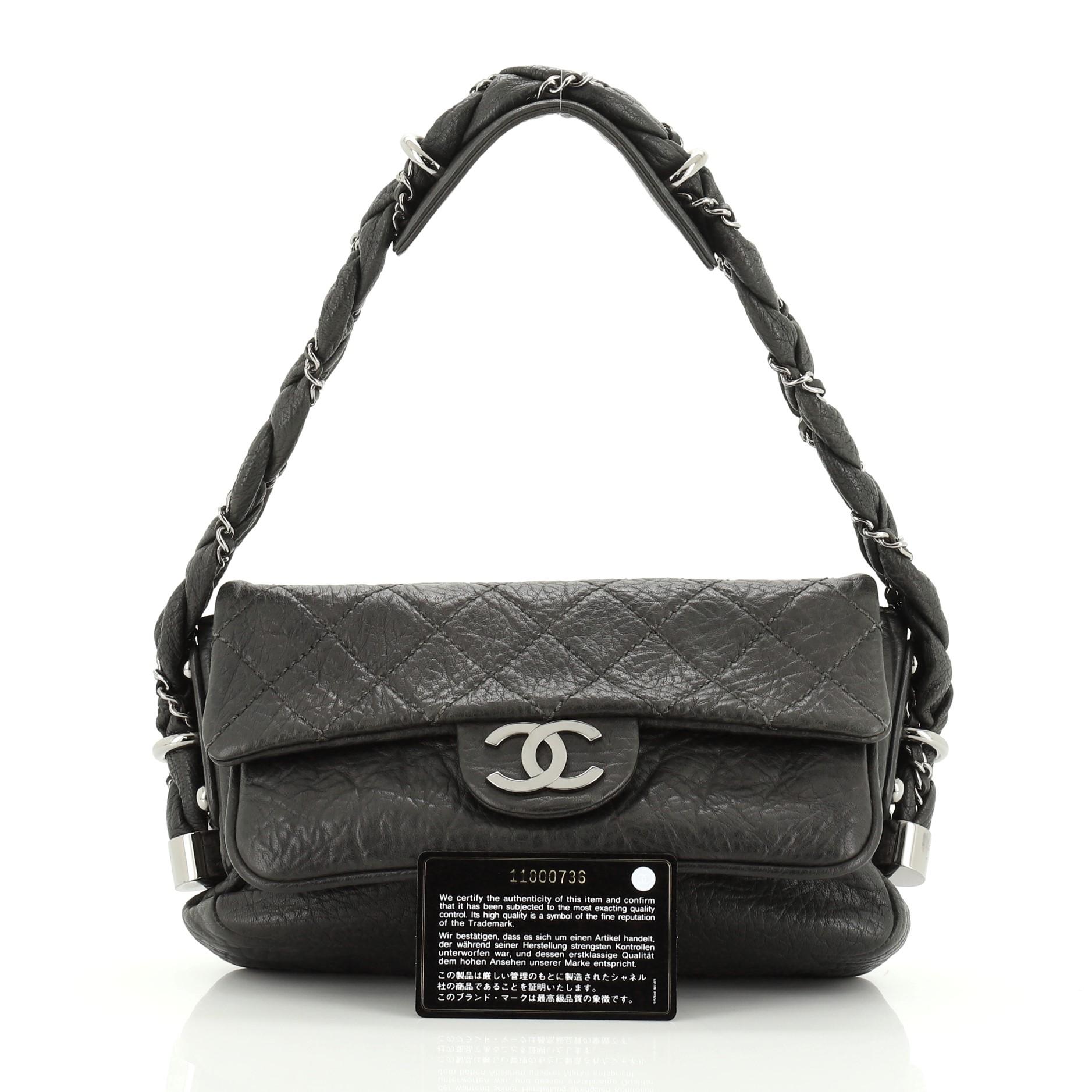 This Chanel Lady Braid Flap Bag Quilted Distressed Lambskin Small, crafted in black quilted distressed lambskin leather, features a braided leather and chain handle, CC logo and gunmetal-tone hardware. Its magnetic snap closure opens to a gray satin