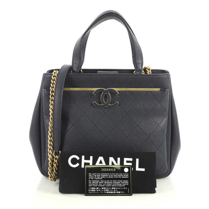 This Chanel Lady Coco Shopping Tote Quilted Caviar Small, crafted from blue leather, features dual flat leather handles, protective base studs, exterior front pocket and matte gold-tone hardware. Its magnetic snap closure opens to a blue fabric