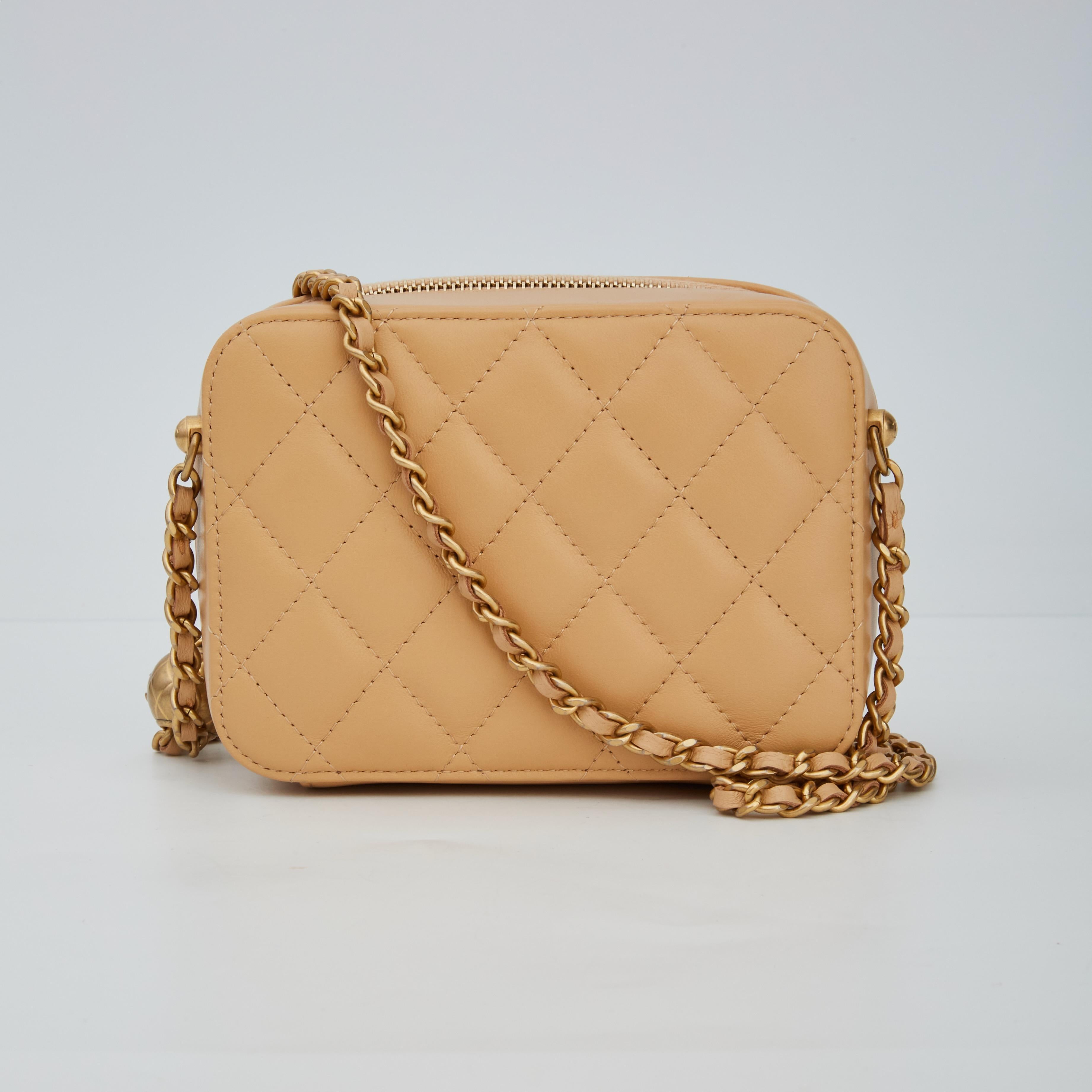 The mini crossbody bag is made in soft quilted lambskin leather. The bag features a gold chain-interlaced with leather shoulder strap, a gold CC logo at front, top zip closure and a beige fabric interior with patch pockets.

COLOR: Beige
MATERIAL: