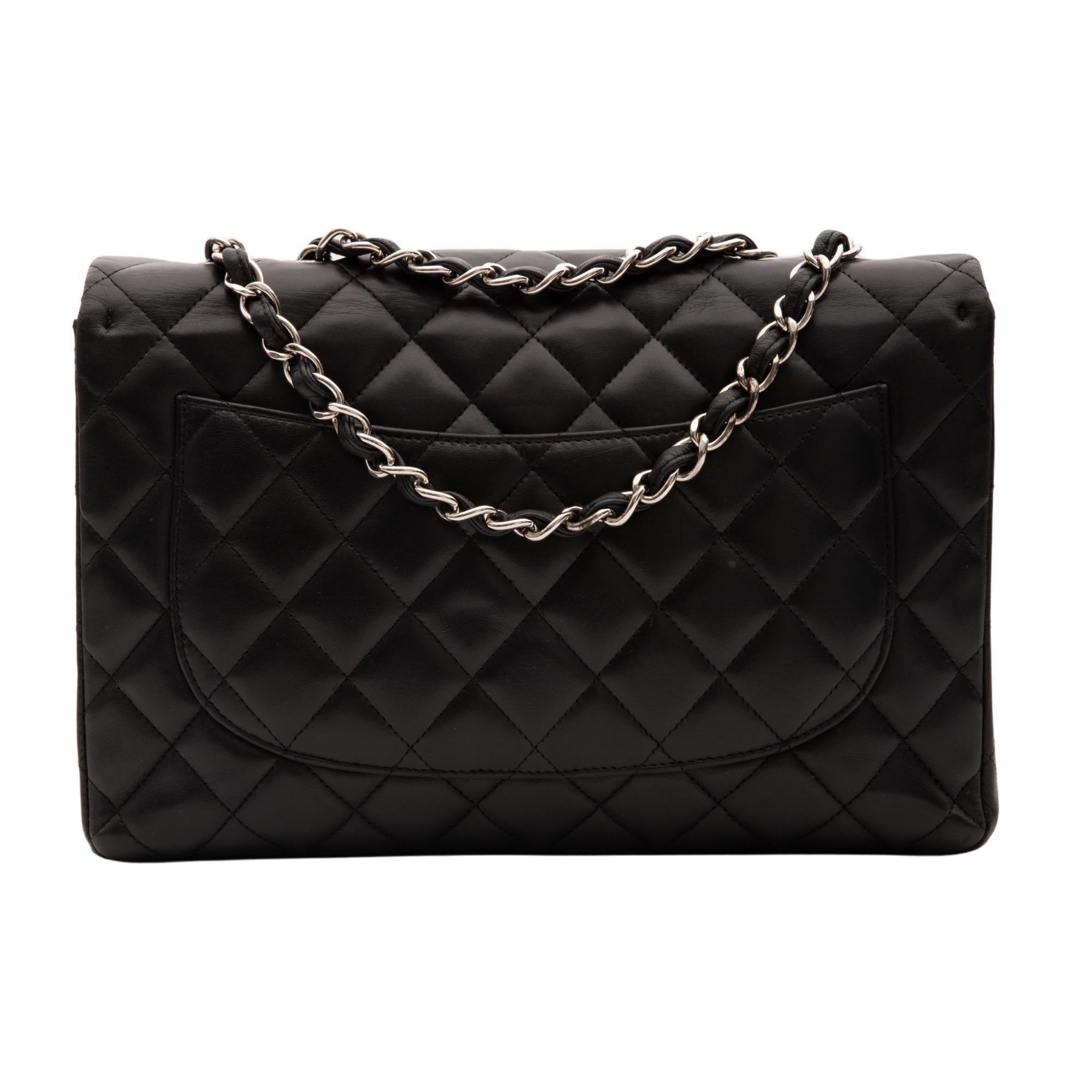 This bag is made with soft and supple lambskin leather in black with diamond quilted stitching. The bag features a single flap, silver tone hardware, CC turn lock closure, back slip pocket and an interior with burgundy leather lining and patch and
