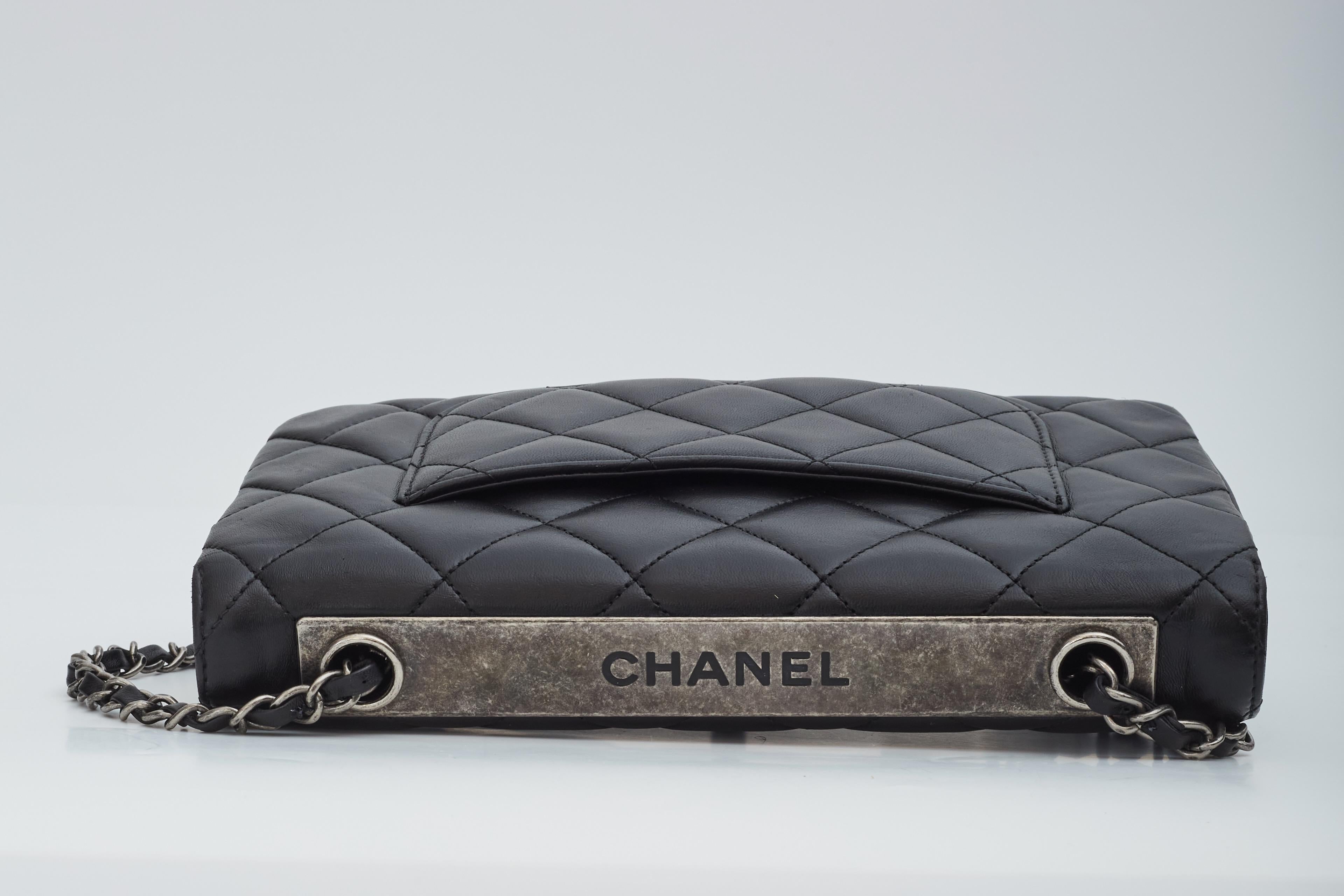 This Chanel Trendy bag is made with lambskin leather in black. The bag features diamond stitching, ruthenium hardware, as short should strap of chain and leather, cc turn lock closure, a front flap and a partitioned interior with burgundy leather
