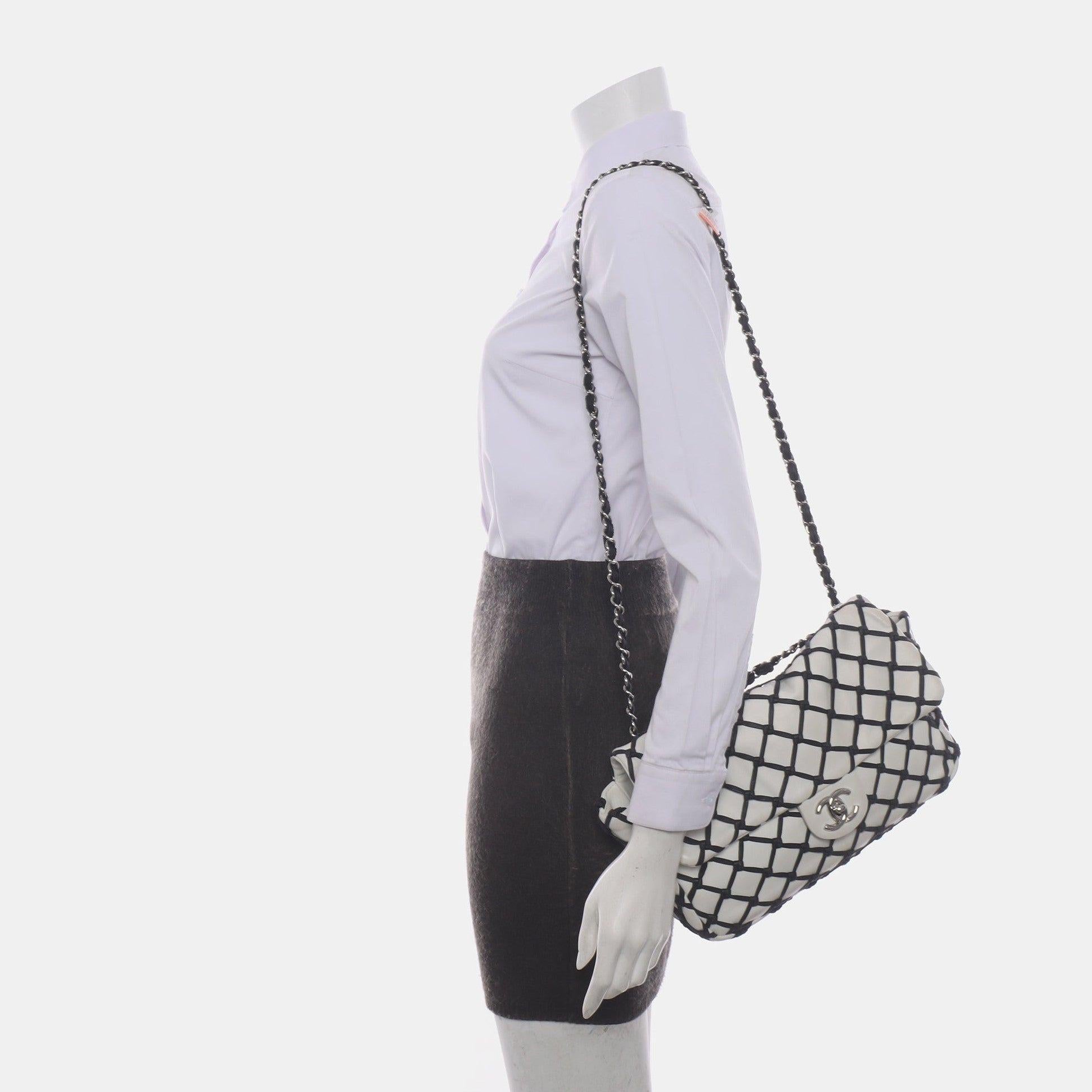 Chanel Lambskin Jumbo Canebiers Net Knots Flap White, 2011
 These are professional photos of the actual bag offered by Luxbags.
 This CHANEL bag is an authentic Lambskin Jumbo Canebiers Net Flap, featuring a classic design and made with smooth