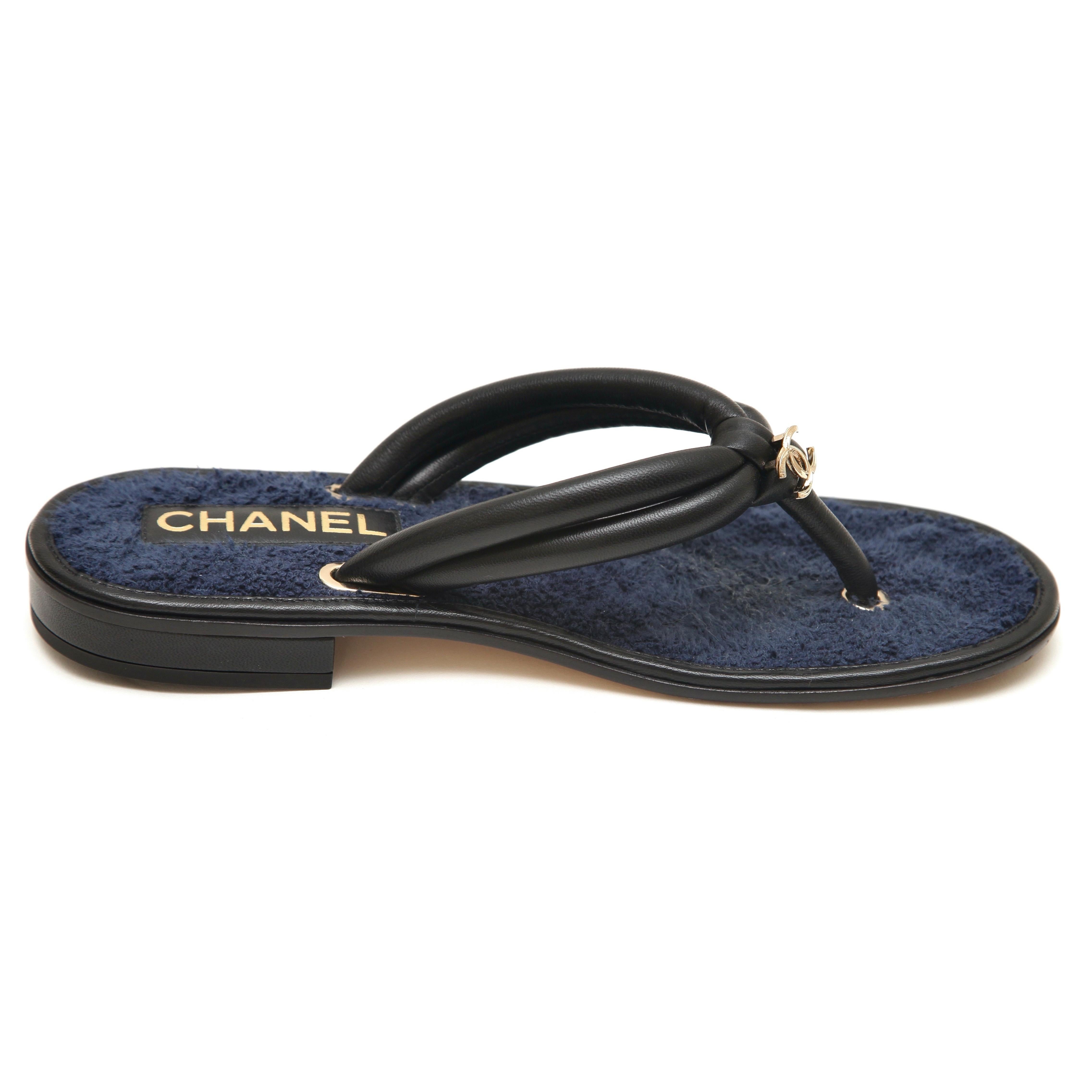 GUARANTEED AUTHENTIC 2021 BLACK LEATHER NAVY FABRIC THONG SANDALS


Design:
- Leather and fabric uppers.
- CC logo in gold at top.
- Thong style lip on.
- Fabric insole, leather outsole.
- Comes with dust bags.

Size: 38C

Measurements