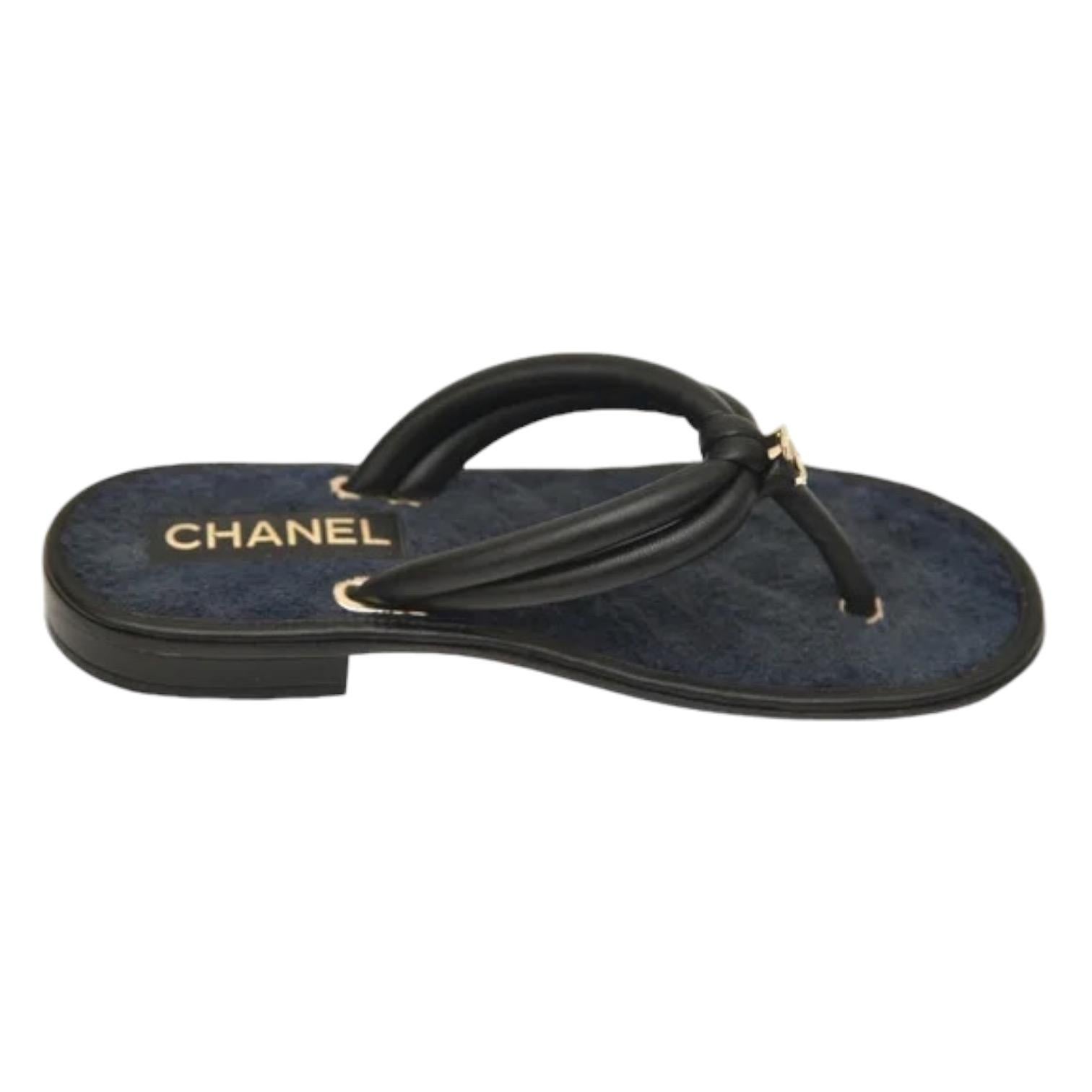 GUARANTEED AUTHENTIC 2021 BLACK LEATHER NAVY FABRIC THONG SANDALS


Design:
- Leather and fabric uppers.
- CC logo in gold at top.
- Thong style lip on.
- Fabric insole, leather outsole.
- Comes with dust bags.

Size: 38C

Measurements