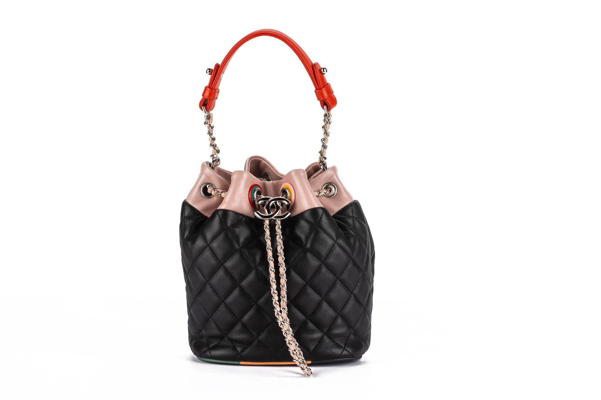 This Chanel Lambskin Quilted Cuba Drawstring Bucket Bag in Multicolor is a super-chic tote crafted of lambskin diamond quilted leather with silver hardware. The bag features a top handle and a silver chain link leather threaded drawstring with a