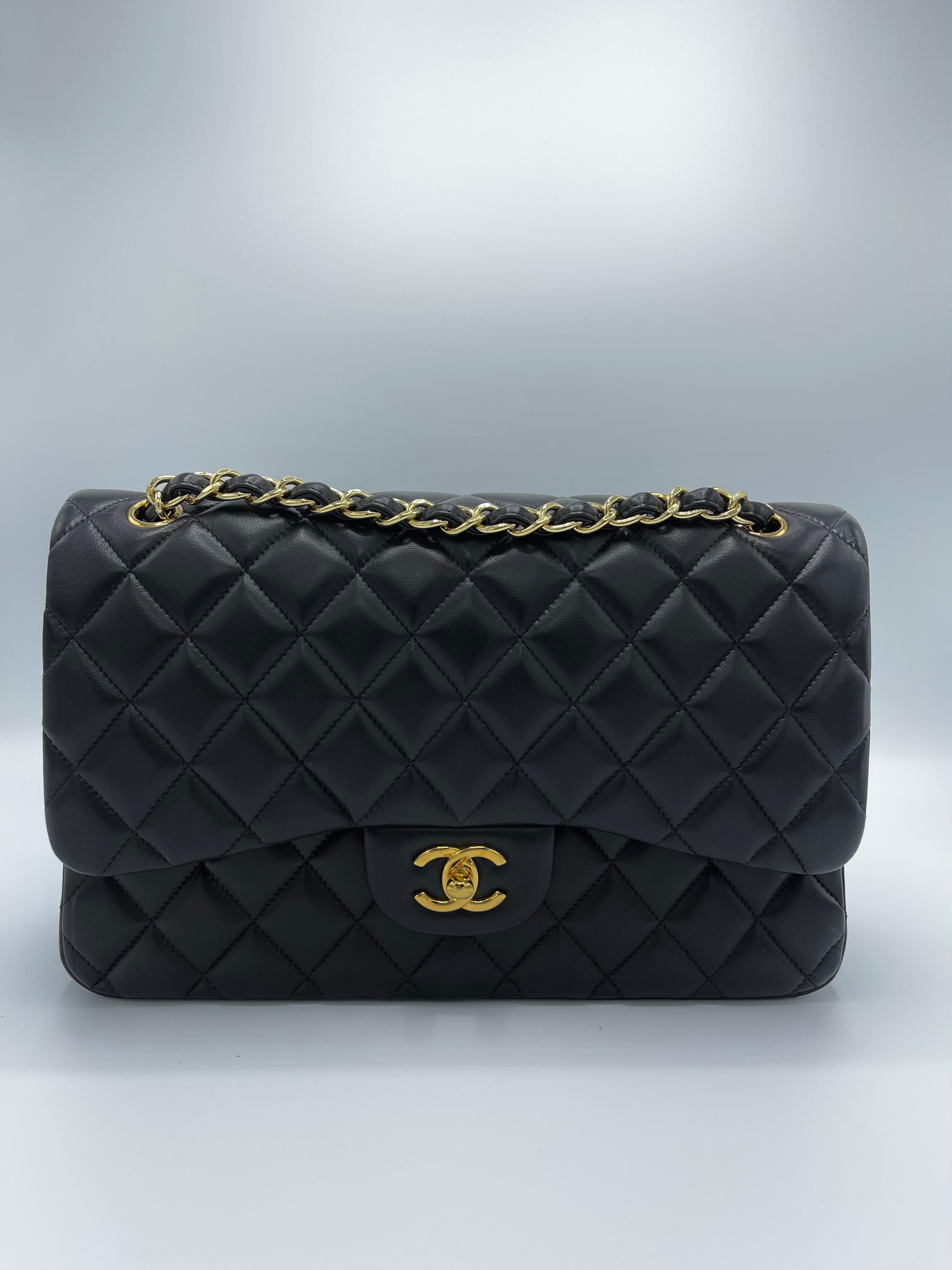 The famous Chanel Classic Double Flap new model shoulder bag is created in black diamond-quilted lambskin leather and adorned with gold-tone turnlock and chain hardware from an early 2010 collection. 
The bag has a polished gold leather-threaded