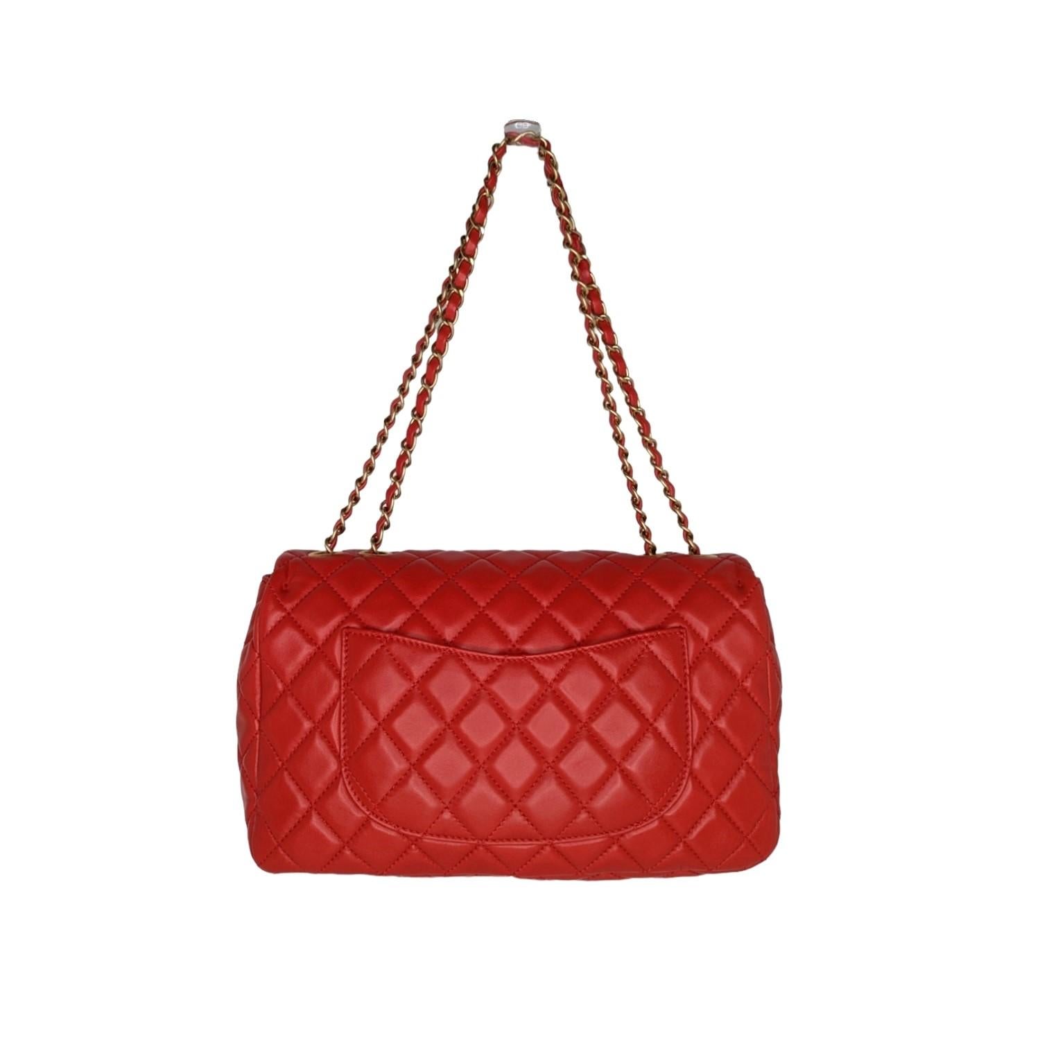 The classic features and exceptional quality of this Chanel shoulder bag lend a look of timeless elegance for day or evening. The bag is a large, structured shoulder bag that is crafted of lambskin diamond quilted leather in red. This bag features