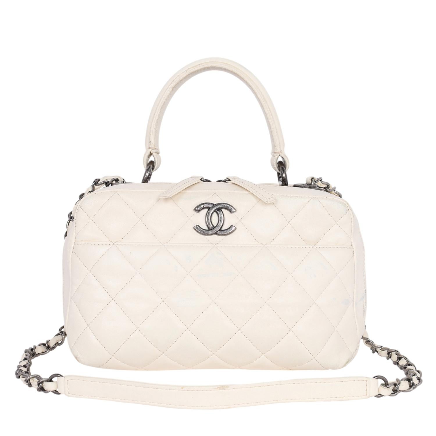 Authentic, pre-loved Chanel white quilted lambskin leather vanity case shoulder bag. Features quilted leather with antique silver hardware, a long woven silver chain strap, top handle, Chanel top plate, front slip pocket, dual zipper top closure