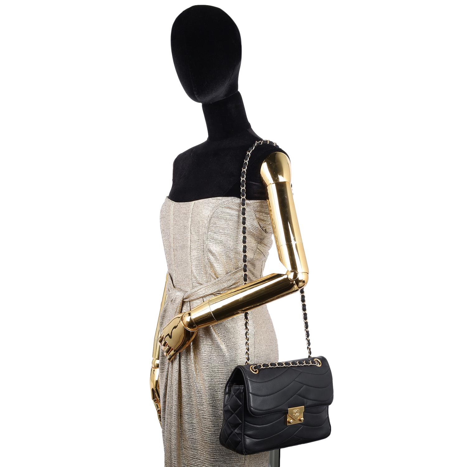 Authentic, pre-owned Chanel Lambskin Scallop Quilted Pagoda Flap Bag in Black. Features smooth lambskin leather with a unique wave scalloped quilting at the front and back of the bag, diamond stitched sides that wrap around the bottom of the bag,