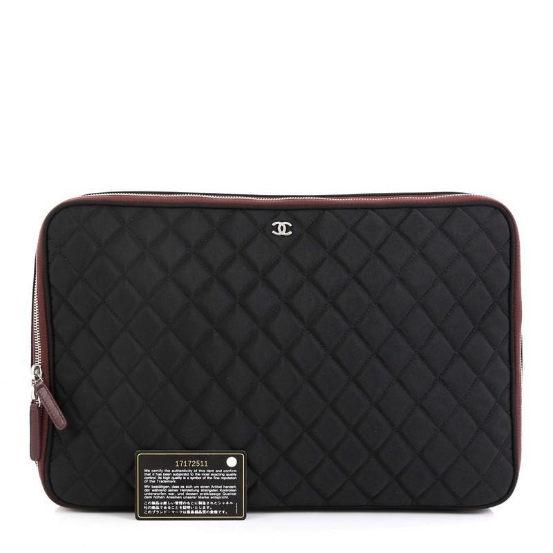 This Chanel Laptop Sleeve Quilted Nylon, crafted from black nylon, features Chanel's signature diamond quilted design, small silver CC logo and silver-tone hardware. Its all-around zip closure opens to a red nylon interior. Hologram sticker reads: