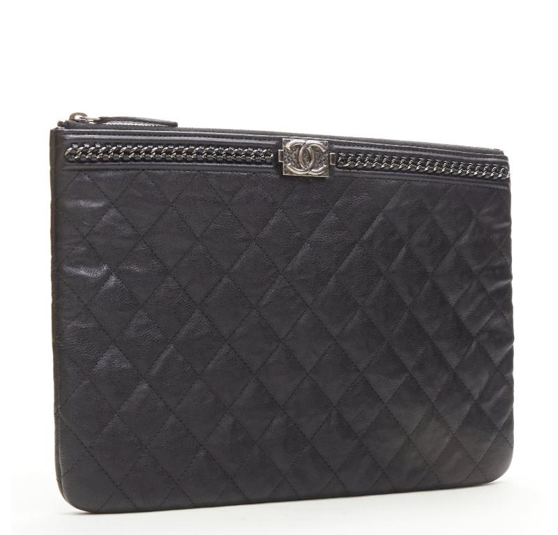 CHANEL Large Boy O Case black quilted leather chain trim flat pouch clutch bag
Reference: TGAS/C01209
Brand: Chanel
Designer: Karl Lagerfeld
Model: O Case
Material: Leather
Color: Black, Silver
Pattern: Solid
Closure: Zip
Lining:  Nylon
Extra
