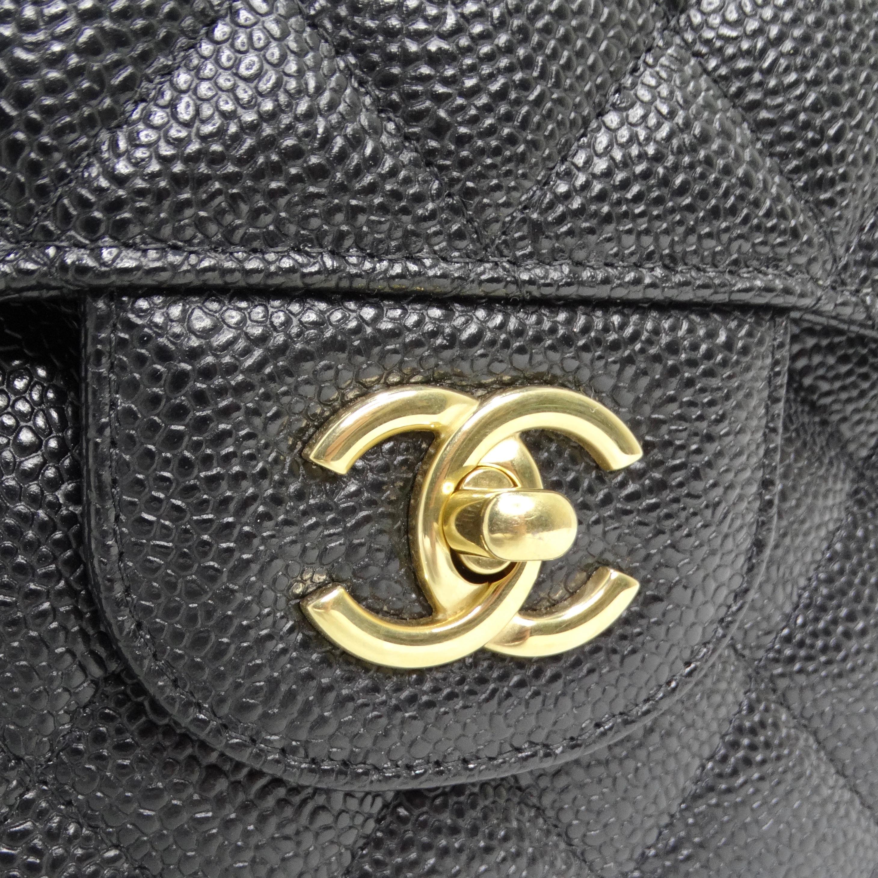 Introducing the Chanel Large Classic Quilted Caviar Handbag in a stunning Black/Burgundy combination, a timeless masterpiece of elegance and sophistication. This is an authentic CHANEL Caviar Quilted Large Double Flap in Black, the epitome of luxury