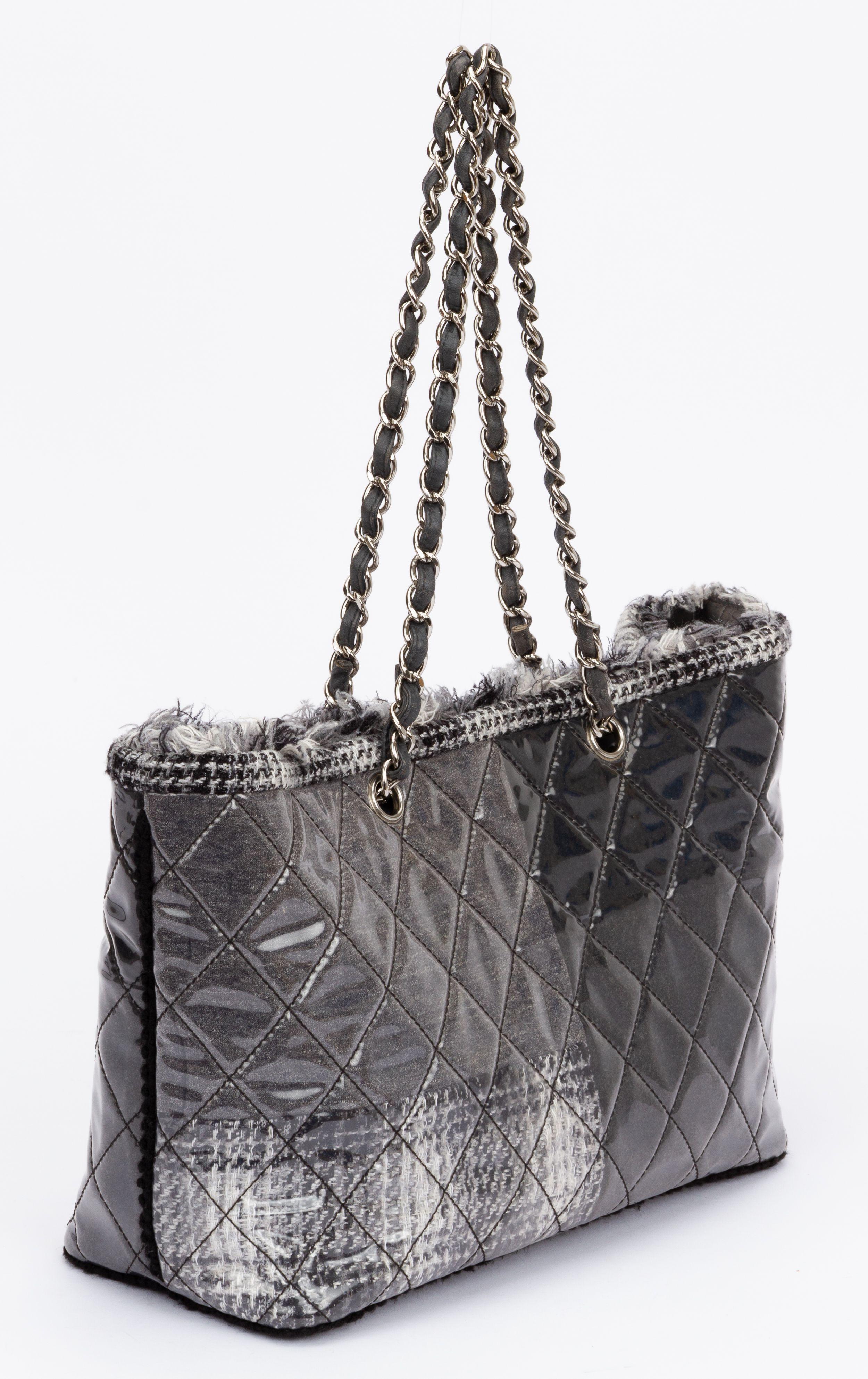 Chanel tote from the 2009 Karl Lagerfeld Collection. The bag is crafted of vinyl in silver grey and comes with a funny tweed pattern. It has fringe trim accent and silver-tone hardware. The shoulder chain has a drop of 10.25
