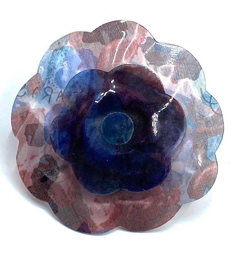 A whopping 3.5 inches in diameter is this Chanel laminated printed sheer fabric Camelia brooch from the 1990s. Upon close inspection one may see the tiny weave of the sheer fabric inside the lamination. The fabric is printed with an abstract free