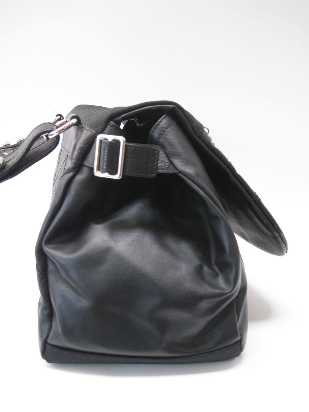 Chanel large black hobo bag.

Sturdy structured leather construction.

Bottom and part of front flap are made of a textured canvas.

Silver hardware throughout. Lampo zippers.

Adjustable side buckles.

Quilted flap and back.

Padded shoulder strap