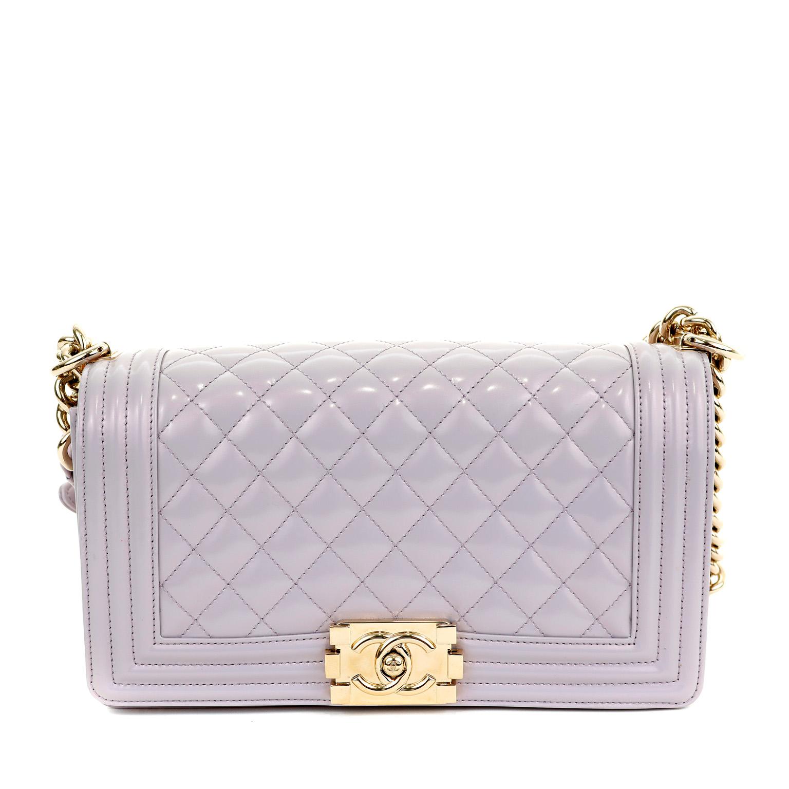 This authentic Chanel Lavender Patent Leather Medium Boy Bag is in pristine condition. The updated design is structured and edgy with a versatility that makes it extremely popular. 

Durable and weather friendly pastel lavender patent leather with