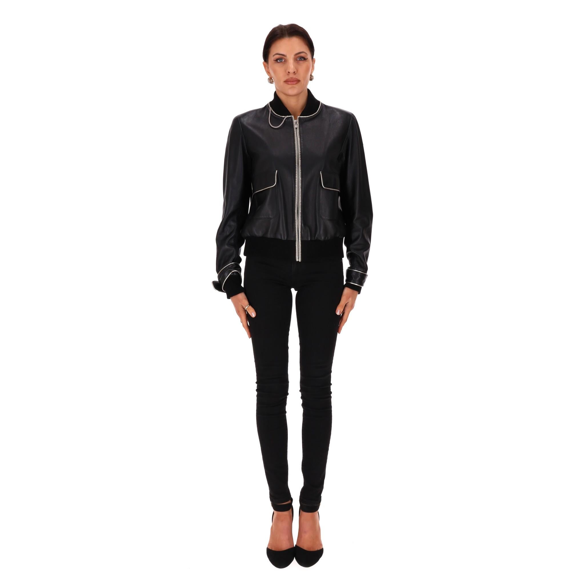 Rare Item - Chanel Leather Bomber Jacket With Pearl Buttons

Black jacket crafted of lambskin leather with silver leather piping.

Pearl buttoned cuffs with iconic leather and chain trim.

Flap pockets to the sides, ribbed cuffs and hem. Lined with