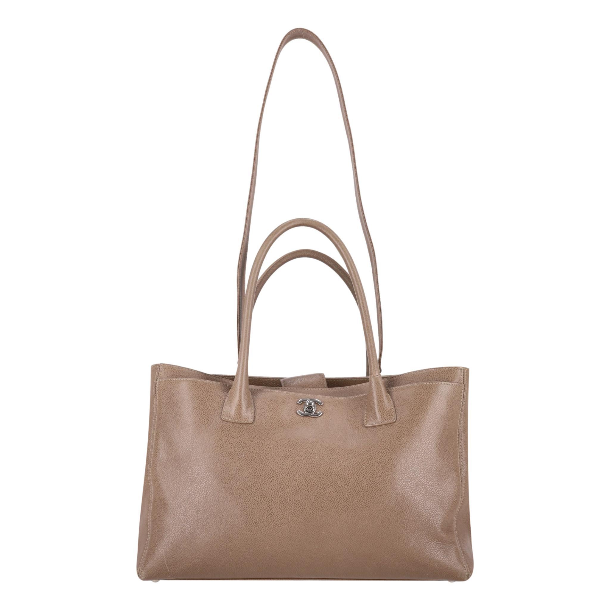Chanel Leather Cerf  Tote Bag

Taupe, caviar pebbled leather bag with top carry handles and removable

shoulder strap.

Detailed with silver hardware and iconic 'CC' logo to the front.

Featuring snap buttoned top leading to spacious interior with