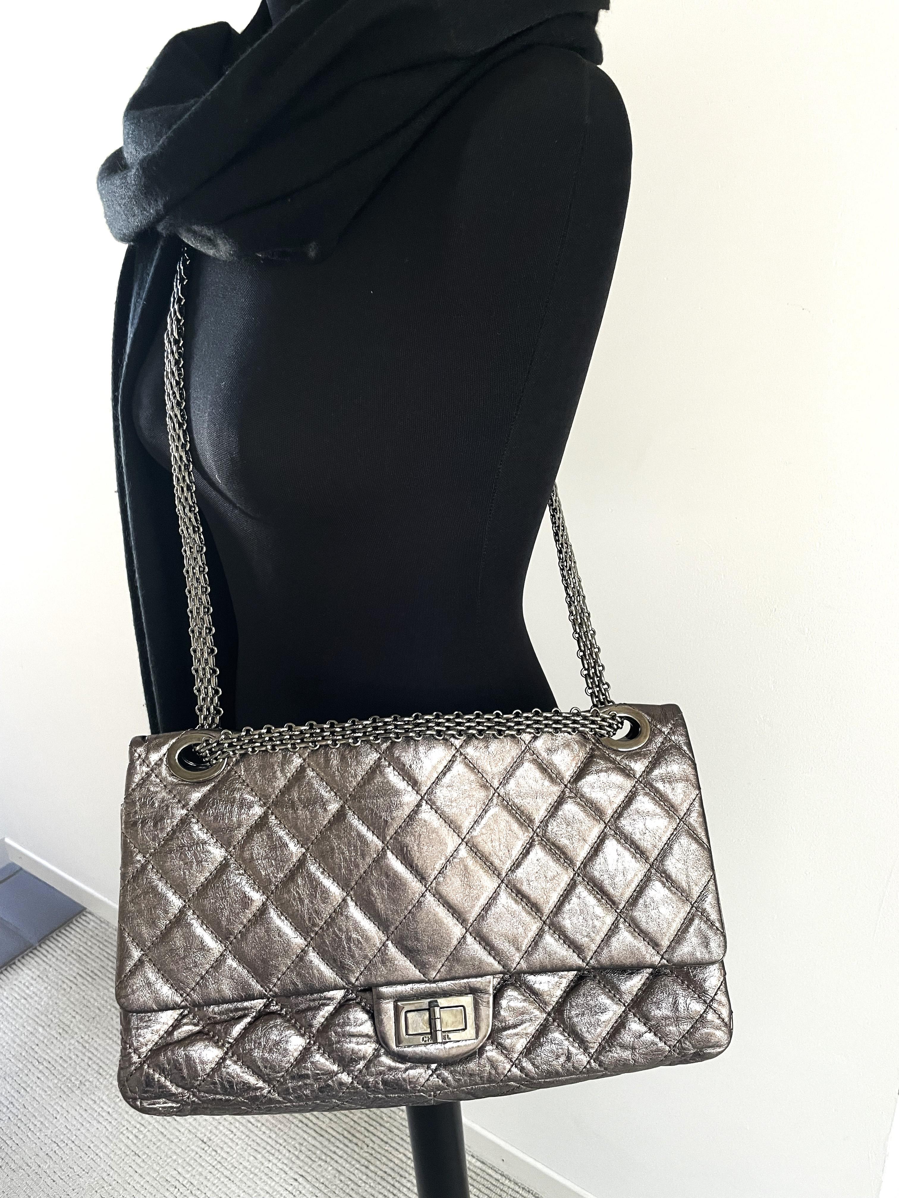 Limited edition maxi Reissure double flap Chanel bag  in silver metallic-distressed leather and with thick silver chains. Made in Italy. Double chain 62 cm, long with one chain 100 cm.  

Measurements:
Length: 14 inches ( 35,5 cm)
Height:  8  inches