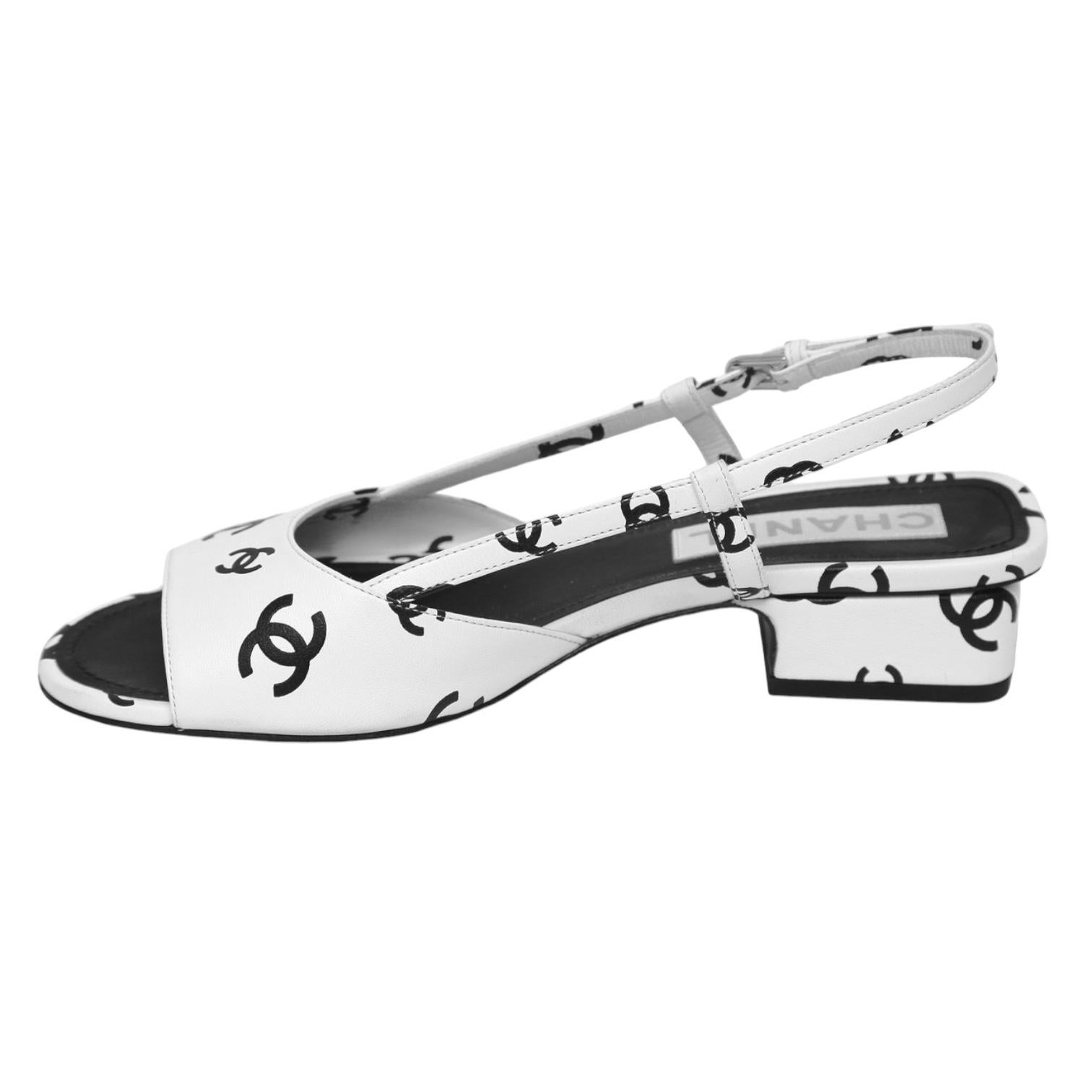 GUARANTEED AUTHENTIC 2022 COLLECTION CHANEL BLACK WHITE CC LOGO LEATHER SANDALS

Design:
- White leather uppers with black CC logo design throughout.
- One strap over top of foot.
- Slingback, silver buckle closure.
- Leather insole and sole.
-