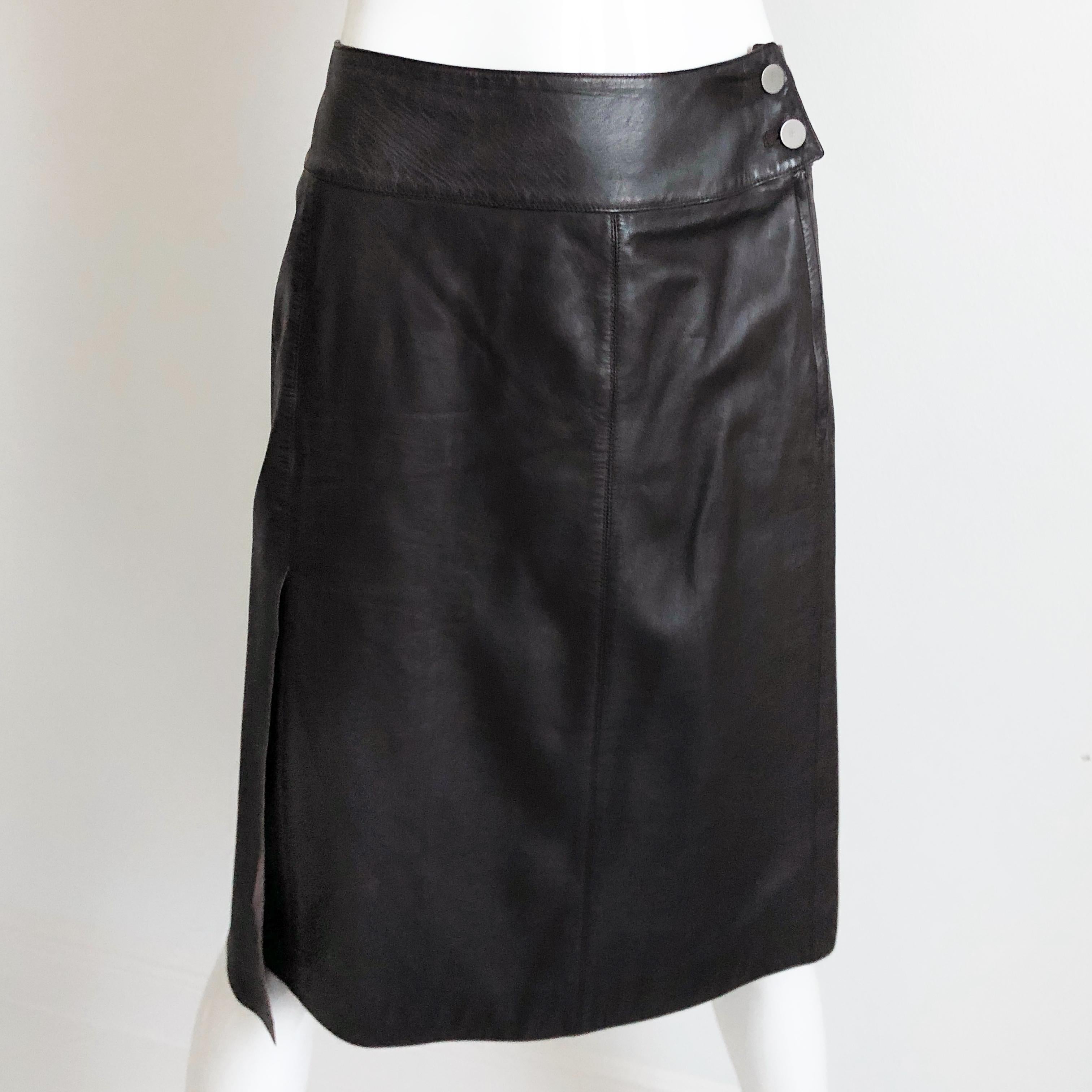 Authentic, preowned, vintage Chanel leather skirt, from the 99P collection.  Made from a buttery soft mocha brown lambskin, it features a slick asymmetric side vent and CC logo stamped buttons.  Fully-lined.  Dry Clean/Leather Clean only.

This