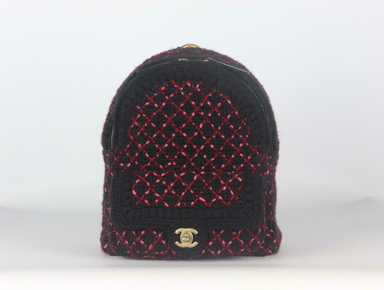 Made in Italy, this beautiful Chanel backpack has been made from black, red and pink wool knitted exterior with pink fabric interior, this piece is decorated with Chanel's antiqued-gold embroidered twist-lock logo on the front and finished with
