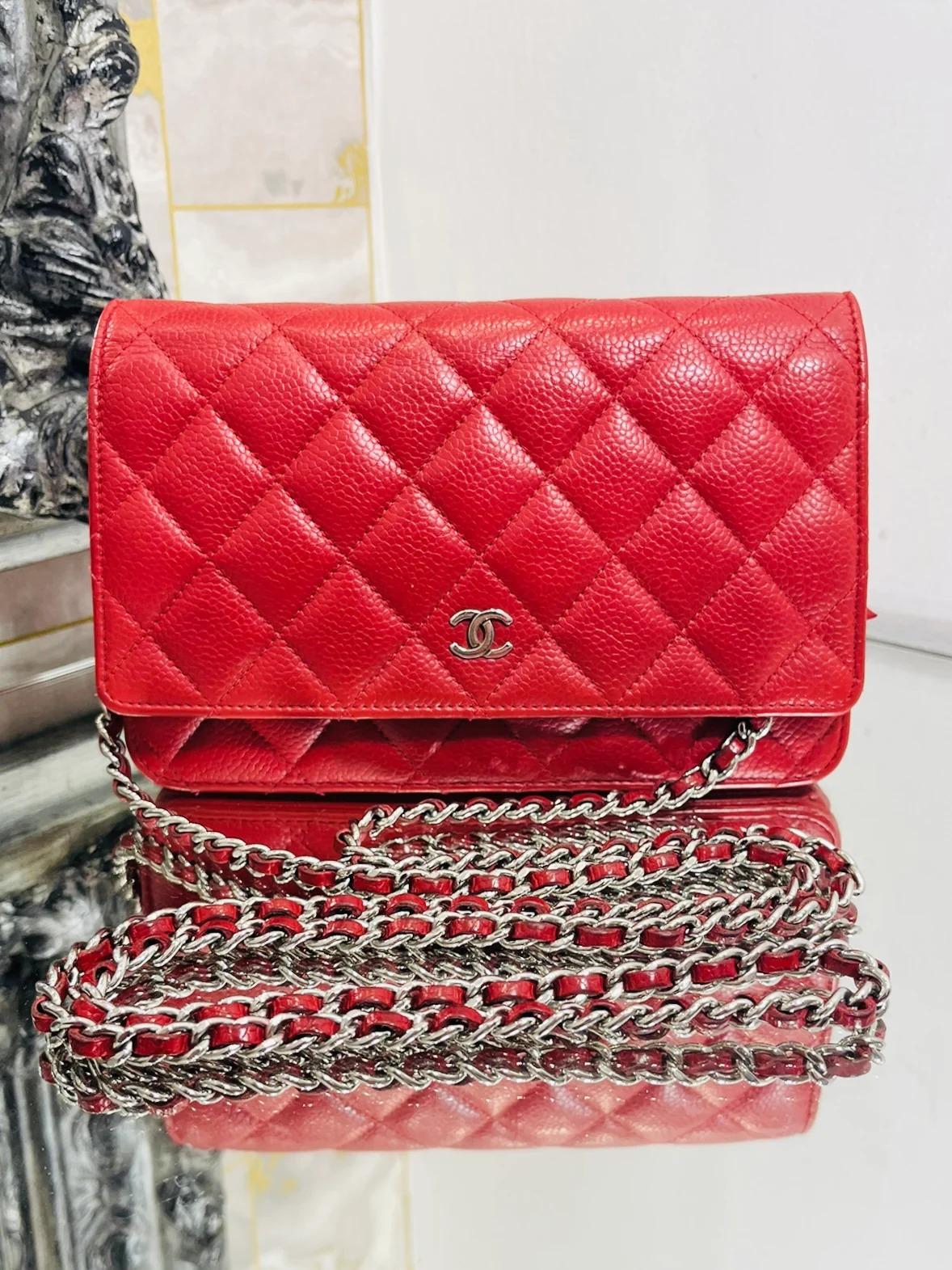 Chanel Leather Wallet On A Chain

Timeless, red, caviar leather, crossbody bag with signature diamond stitching. Silver 'CC' logo to the front and iconic leather and chain strap. Features a rear open pocket, internal  card slots and a zipper pocket.
