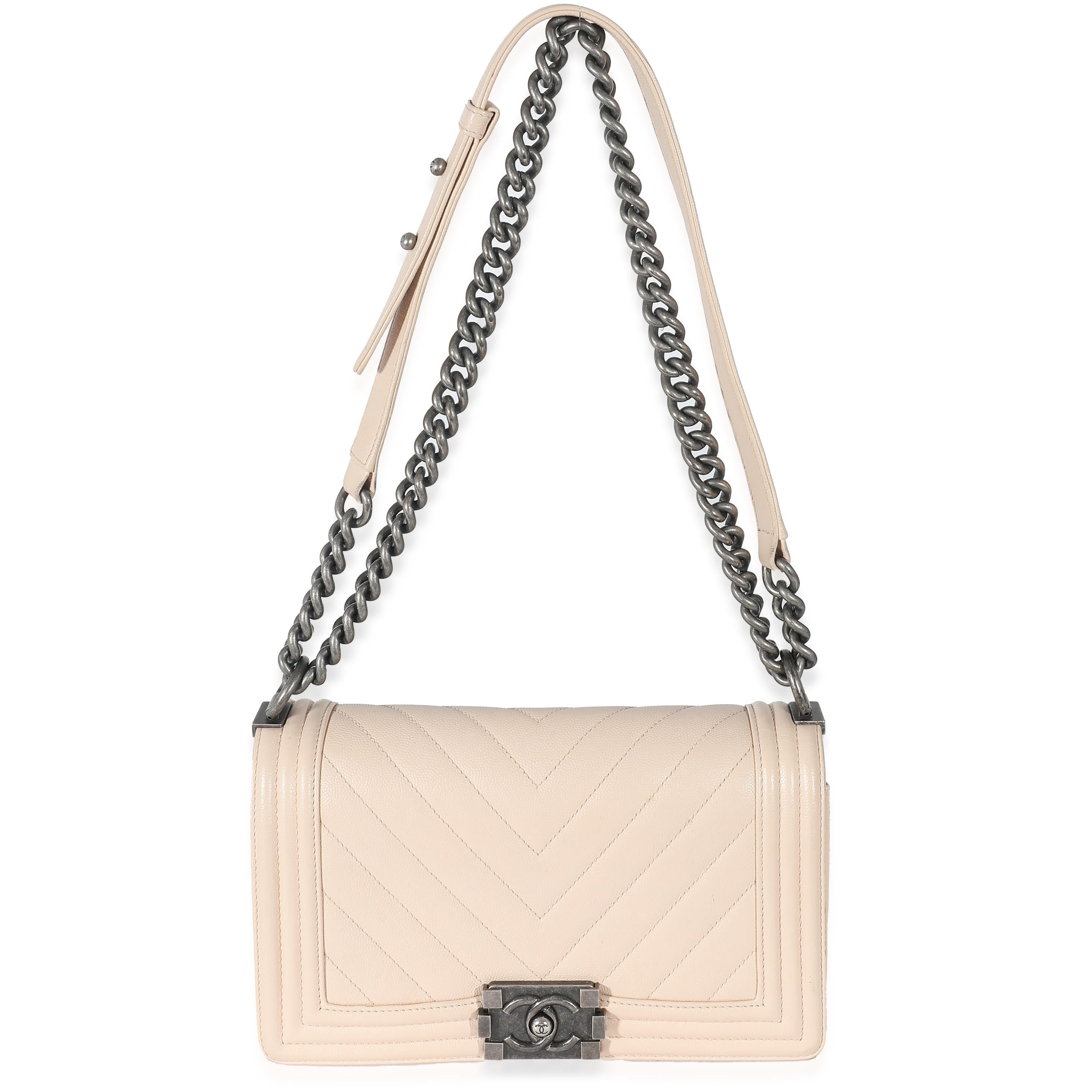 Listing Title: Chanel Light Beige Chevron Quilted Caviar Leather Medium Boy Bag
SKU: 132753
MSRP: 6600.00 USD
Condition: Pre-owned 
Handbag Condition: Very Good
Condition Comments: Item is in very good condition with minor signs of wear. Exterior