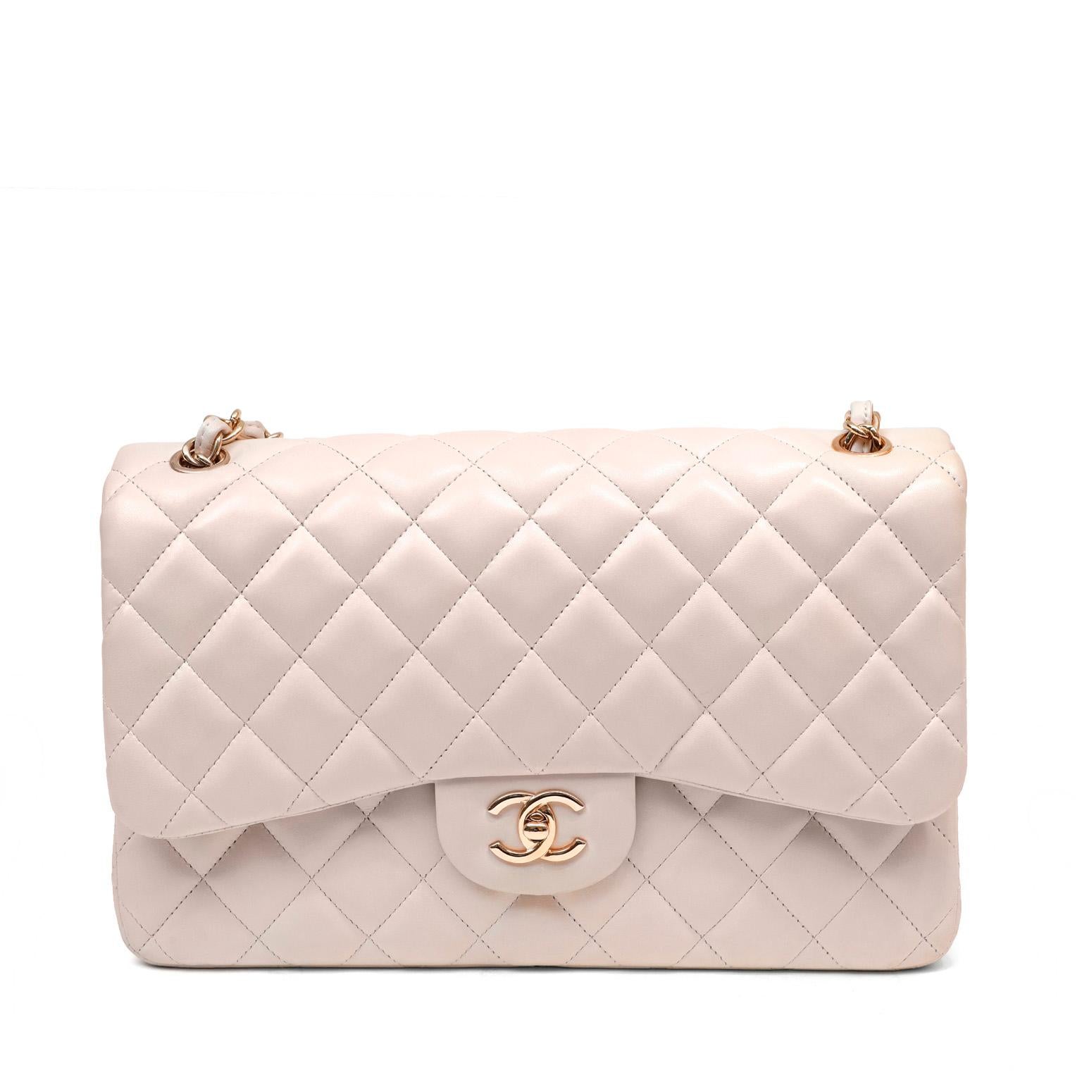 This authentic Chanel Light Beige Lambskin Jumbo Classic Flap is in pristine condition.  The highly sought-after Jumbo Classic is breathtaking in this feminine pairing of neutral light beige with rose gold hardware; rare and collectible.

Quilted
