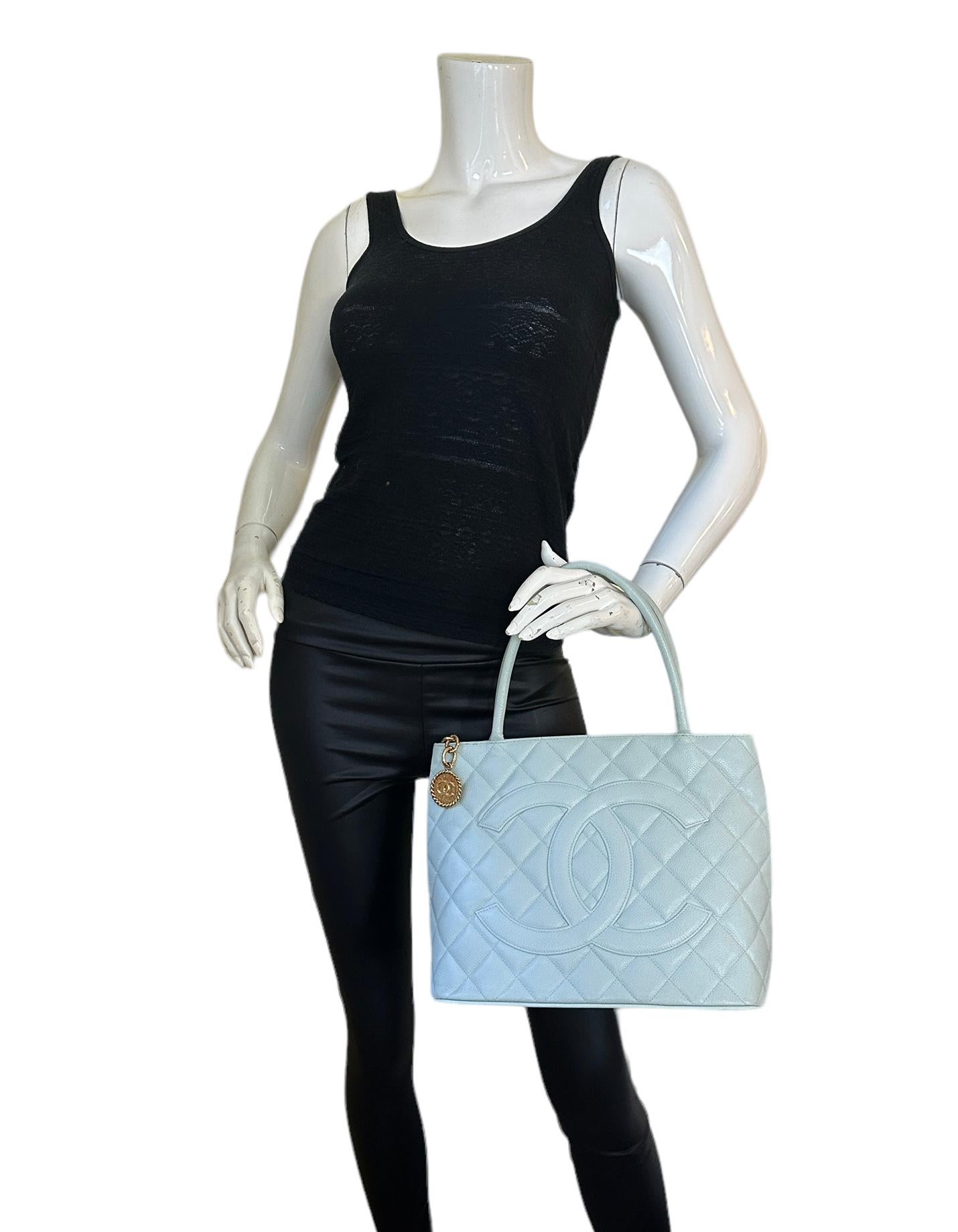 Chanel Light Blue Caviar Leather CC Medallion Tote Bag 

Made In: France
Color: Light blue
Hardware: Goldtone
Materials: Caviar Leather
Lining: Leather
Closure/Opening: Top zip
Exterior Pockets: One flat pocket
Interior Pockets: One zip pocket, one