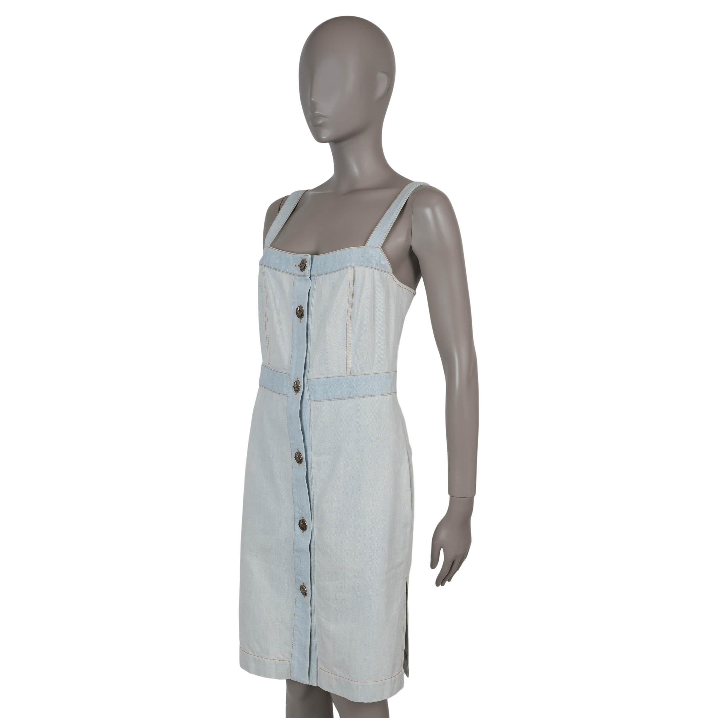This 100% authentic Chanel dress in washed light blue denim cotton (100%) features slightly darker trims for subtle contrast. Designed with a relaxed above-the-knee silhouette, it is sleeveless and detailed with side slit pockets, side slits, and