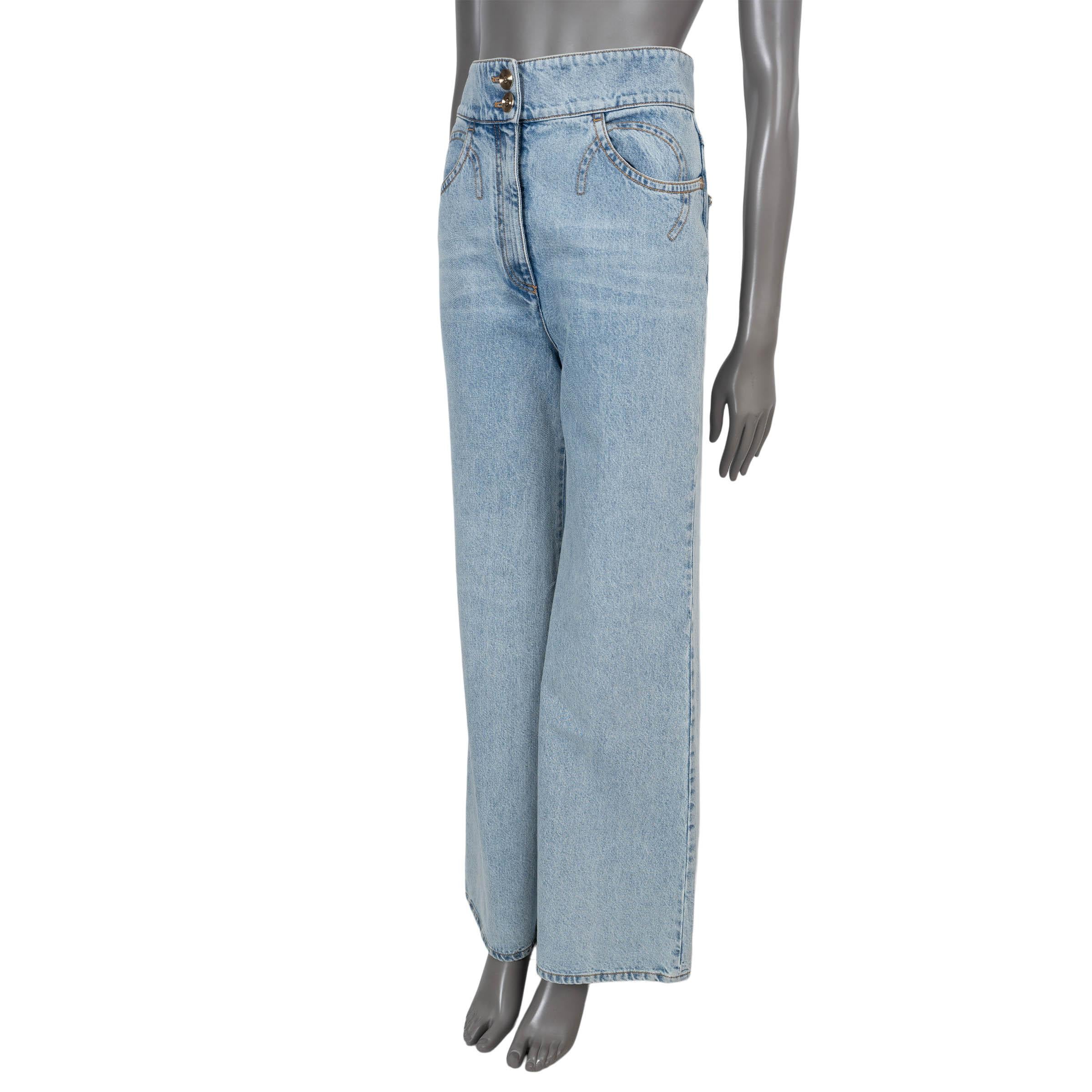 This 100% authentic Chanel wide-leg jeans in light blue denim cotton (100%) offer a chic, vintage-inspired silhouette. Designed with a high waist, they feature two front and two back pockets, with a distressed COCO logo detail on the back for a