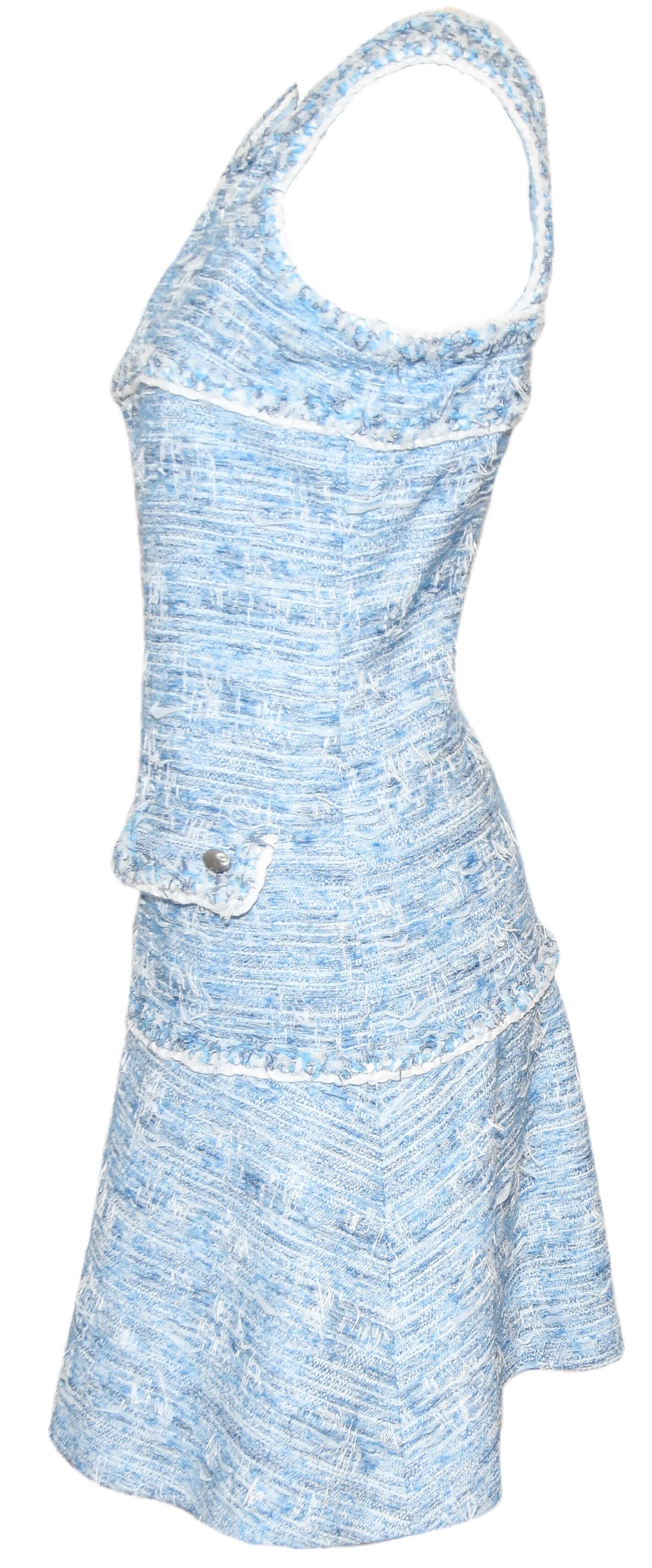Chanel light blue fantasy tweed dress incorporates a scoop neckline and wide straps that are attached at back.   The original straps criss crossed at back and there is not damage to the straps.  This dress contains a braided trim of white piping,