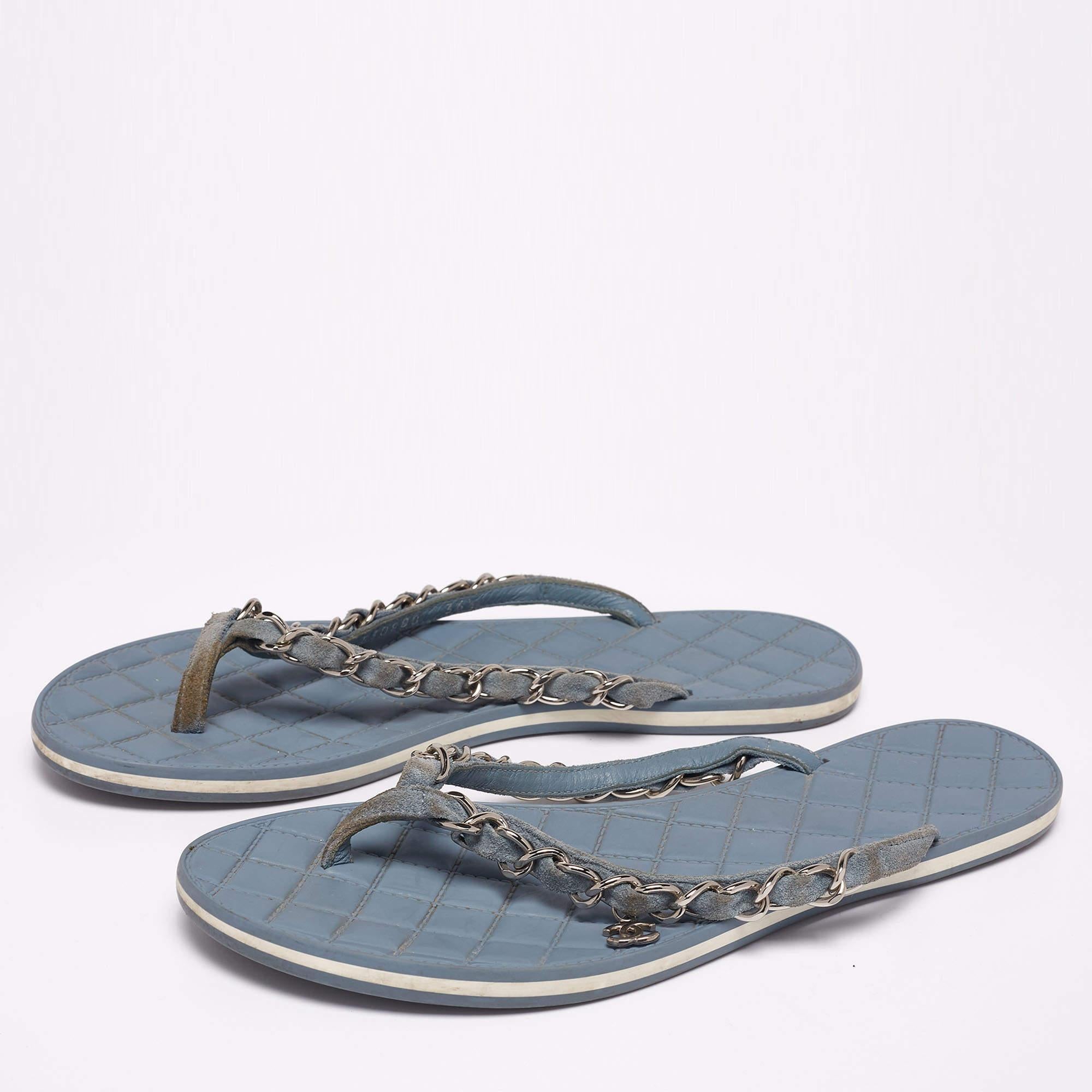 These thong sandals from the House of Chanel are the best way to lend your feet complete comfort and luxury! They are made from light-blue suede, with silver-tone chain-link embellishments elevating their beauty. These sandals will let your feet