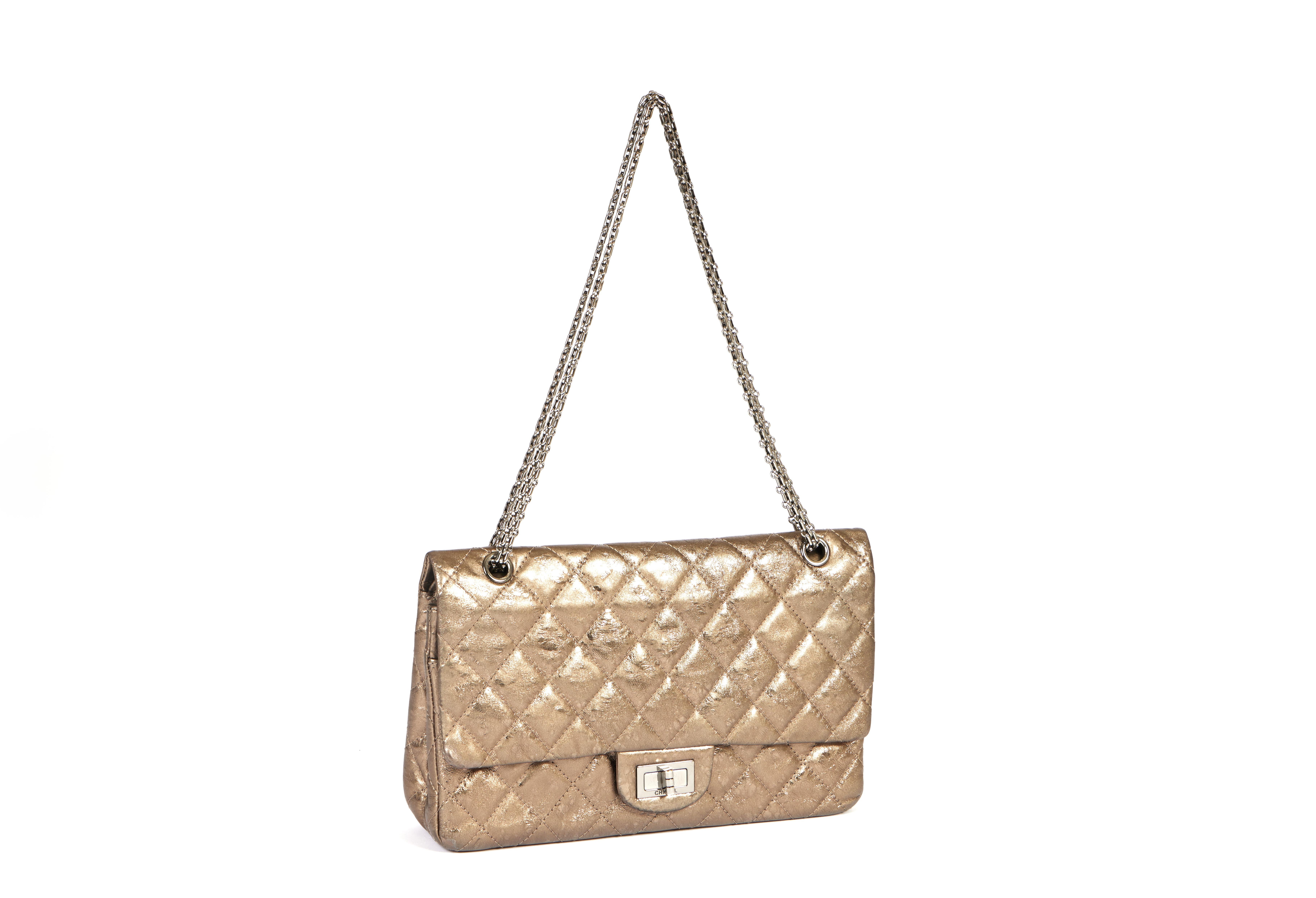 This Chanel 2.55 Reissue Size 227 bag comes in a metallic light bronze tone. The classic chain has a shoulder drop of 11 inches. The bag comes with the inventory card, booklet and Chanel dust bag. According to the hologram number the bag was made in