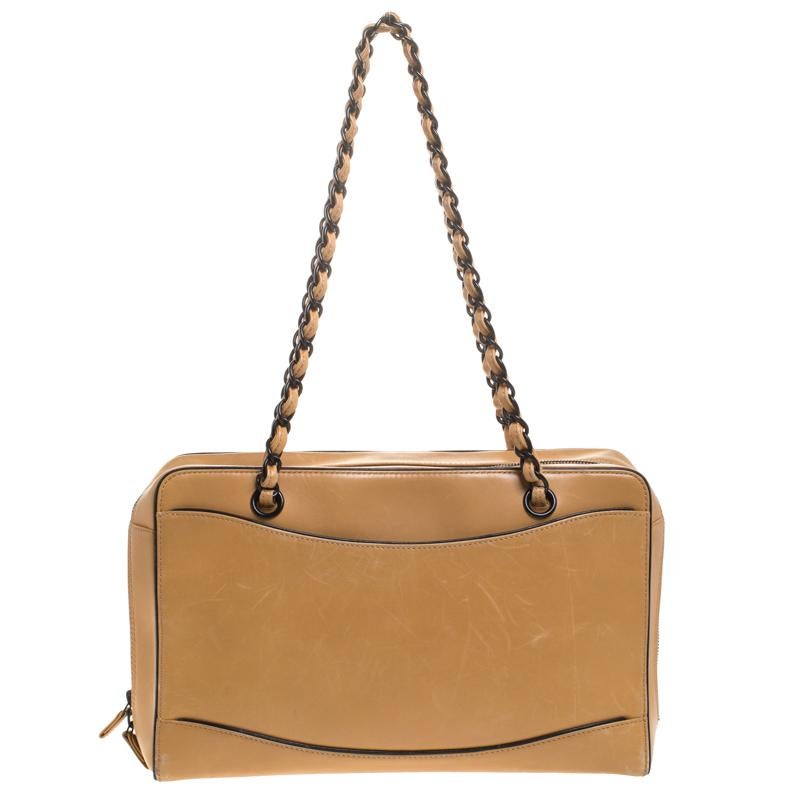Carefully designed to evoke a timeless and fashionable feel, this leather bag is sure to be a prized possession. It features a light brown exterior with contrast trims, two interwoven resin-leather handles and a spacious fabric interior for your