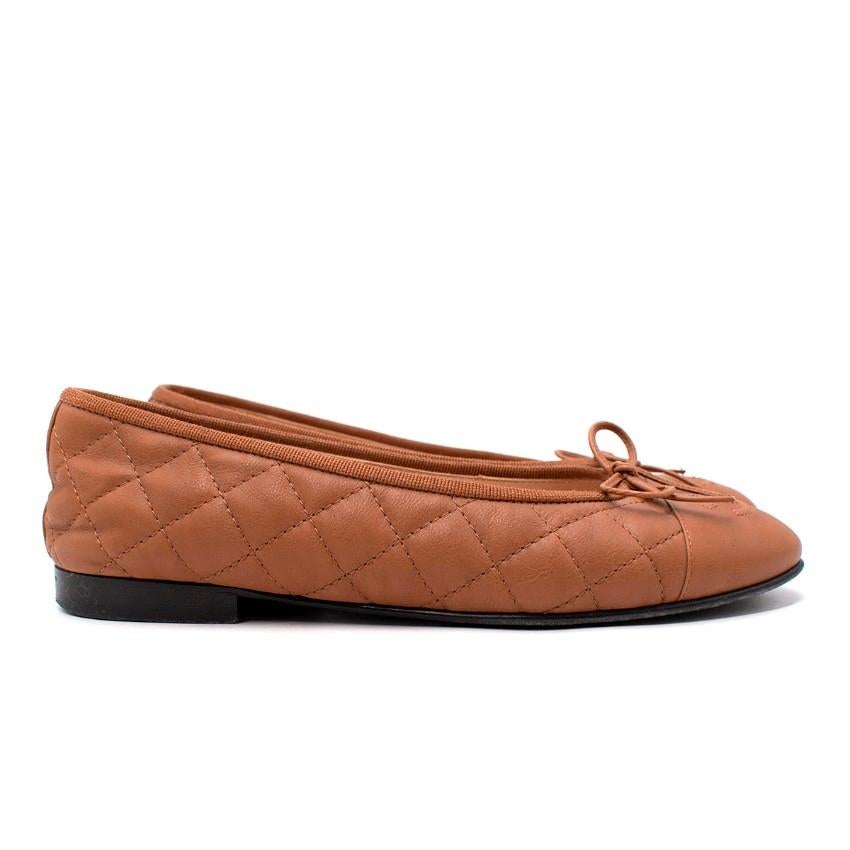 Chanel Light Brown Quilted Leather CC Toe Cap Ballerinas
 

 - Classic Chanel ballerina slipper in a light brown hue
 - Diamond quilted body with signature CC logo toe cap and grosgrain trim 
 - Set on a low block heel
 

 Materials:
 Leather
 

