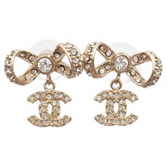 Chanel Light Gold Ribbon Bow CC Crystal Piercing Earrings