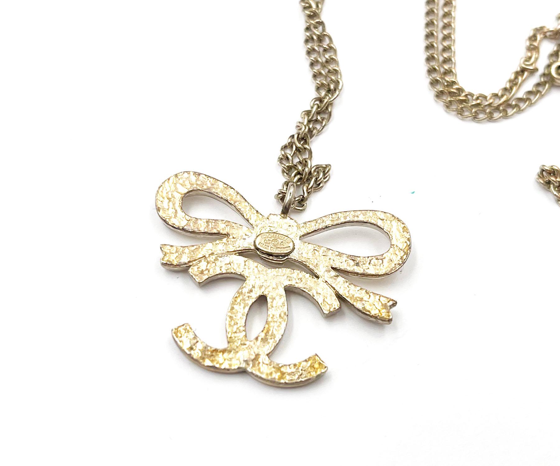 Chanel Classic  Light Gold Ribbon Bow CC Necklace   In Fair Condition For Sale In Pasadena, CA