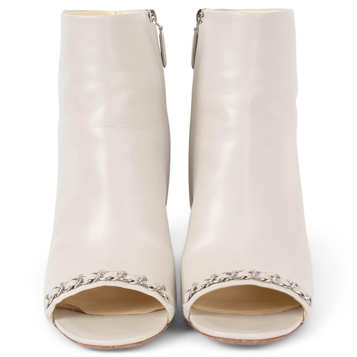 100% authentic Chanel chain trim open-toe ankle-boots in light grey smooth calfskin featuring silver-tone hardware. Have been worn and are in excellent condition. 

2016 Paris-Seoul Resort

Measurements
Model	16C G31529
Imprinted Size	41
Shoe