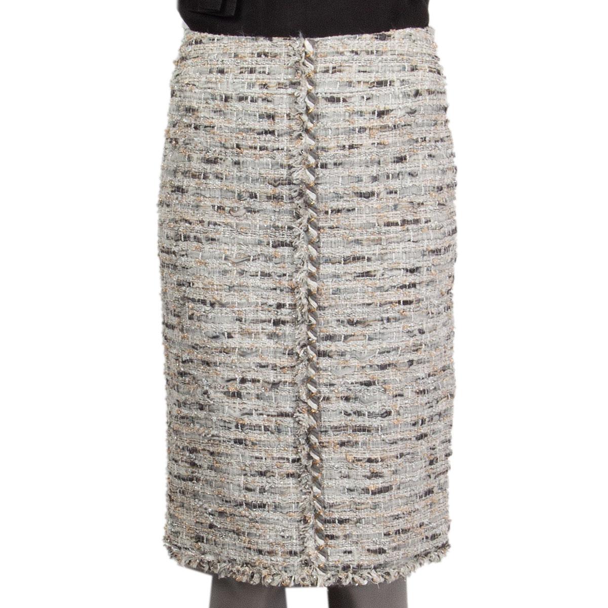 100% authentic Chanel boucle pencil skirt in light grey, grey, gold and silver silk (60%), nylon (10%), polyester (10%), rayon (10%) and cotton (10%) with embroidery on the mid-front and back and at the hem-line. Closes with one hook and a concealed