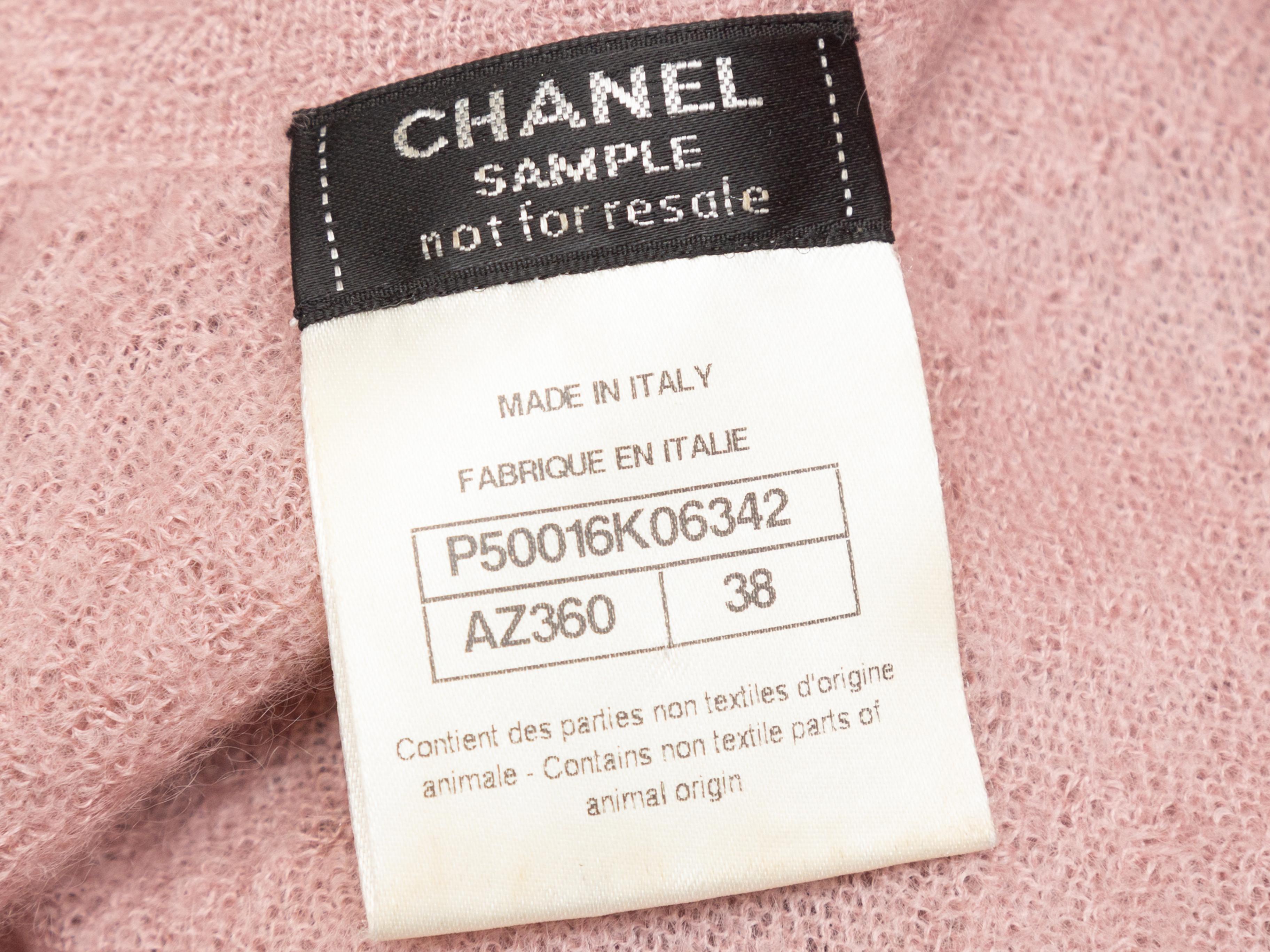 Product details: Light pink mohair and cashmere knit dress by Chanel. Crew neck. Long sleeves. Faux pearl embellishments at bodice. Zip closure at back. 33