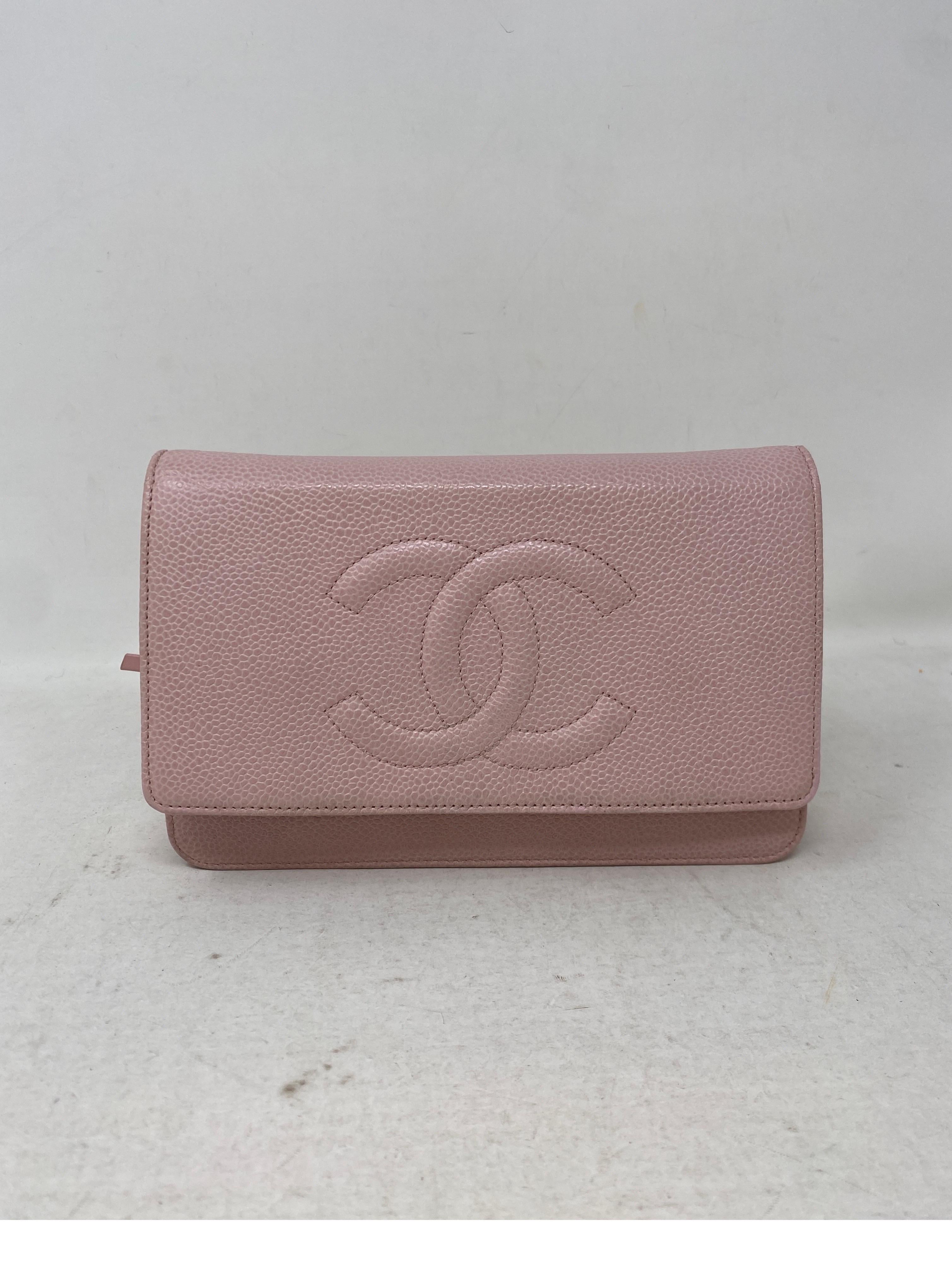 Chanel pink wallet on a chain bag. Excellent condition. Light pink color with caviar leather. Silver hardware. Crossbody bag. Can be worn as a clutch too. Also can be worn doubled. Includes authenticity card and dust bag. Guaranteed authentic. 