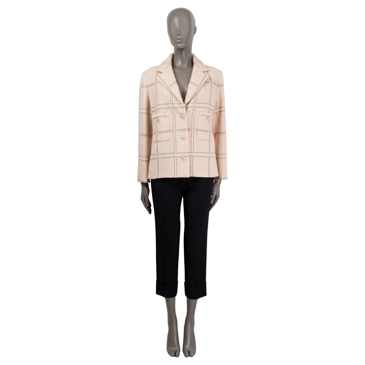100% authentic Chanel 2021 plaid tweed jacket in light pink, ivory and black wool (76%), acrylic (22%), polyester (1%) and polyamide (1%). Opens with three logo embellished buttons in light pink and silver to a light pink lining in silk (100%). The